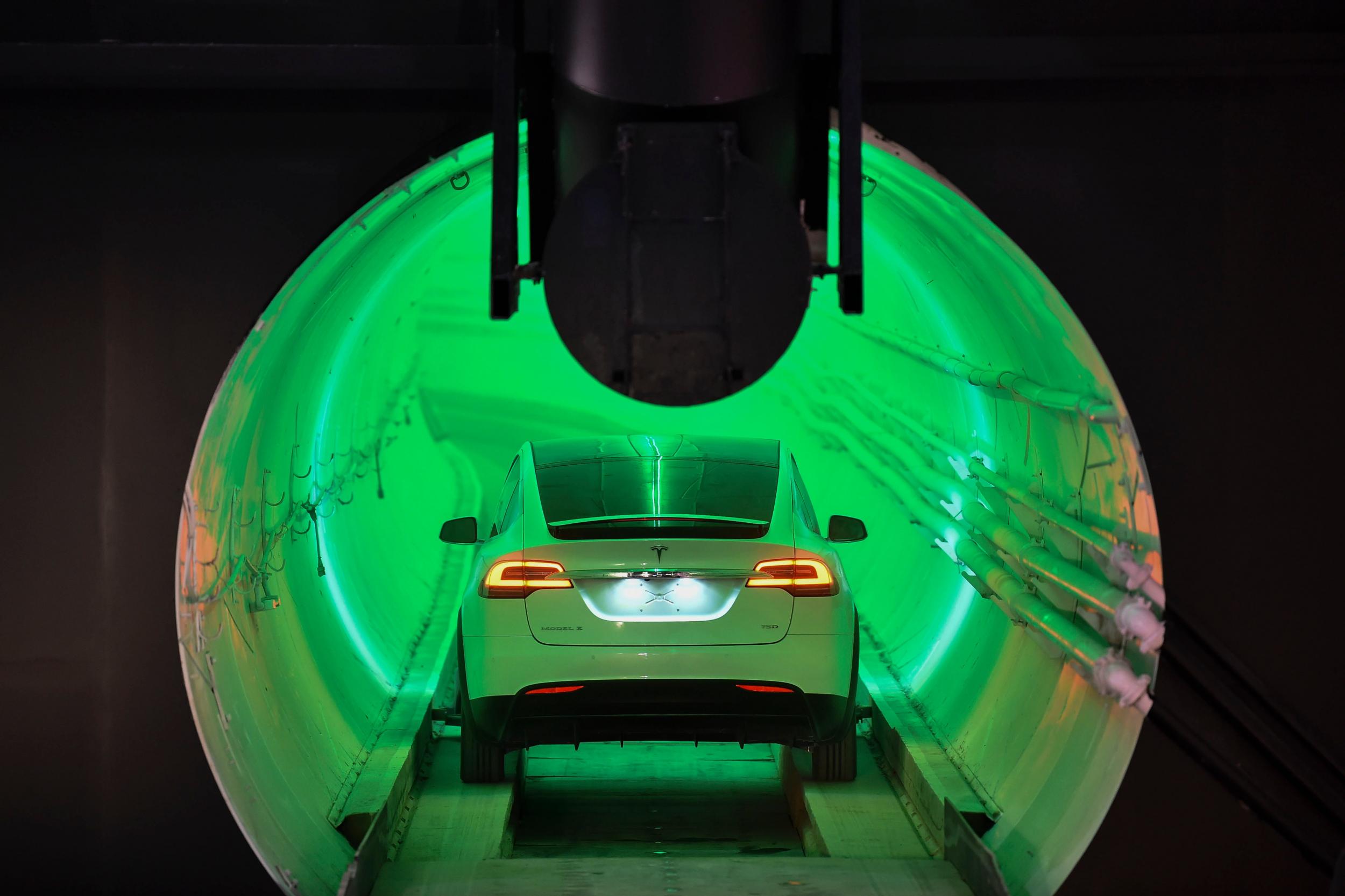 A modified Tesla Model X electric vehicle enters a tunnel before an unveiling event for The Boring Company Hawthorne tunnel in Hawthorne, California, 18 December 2018