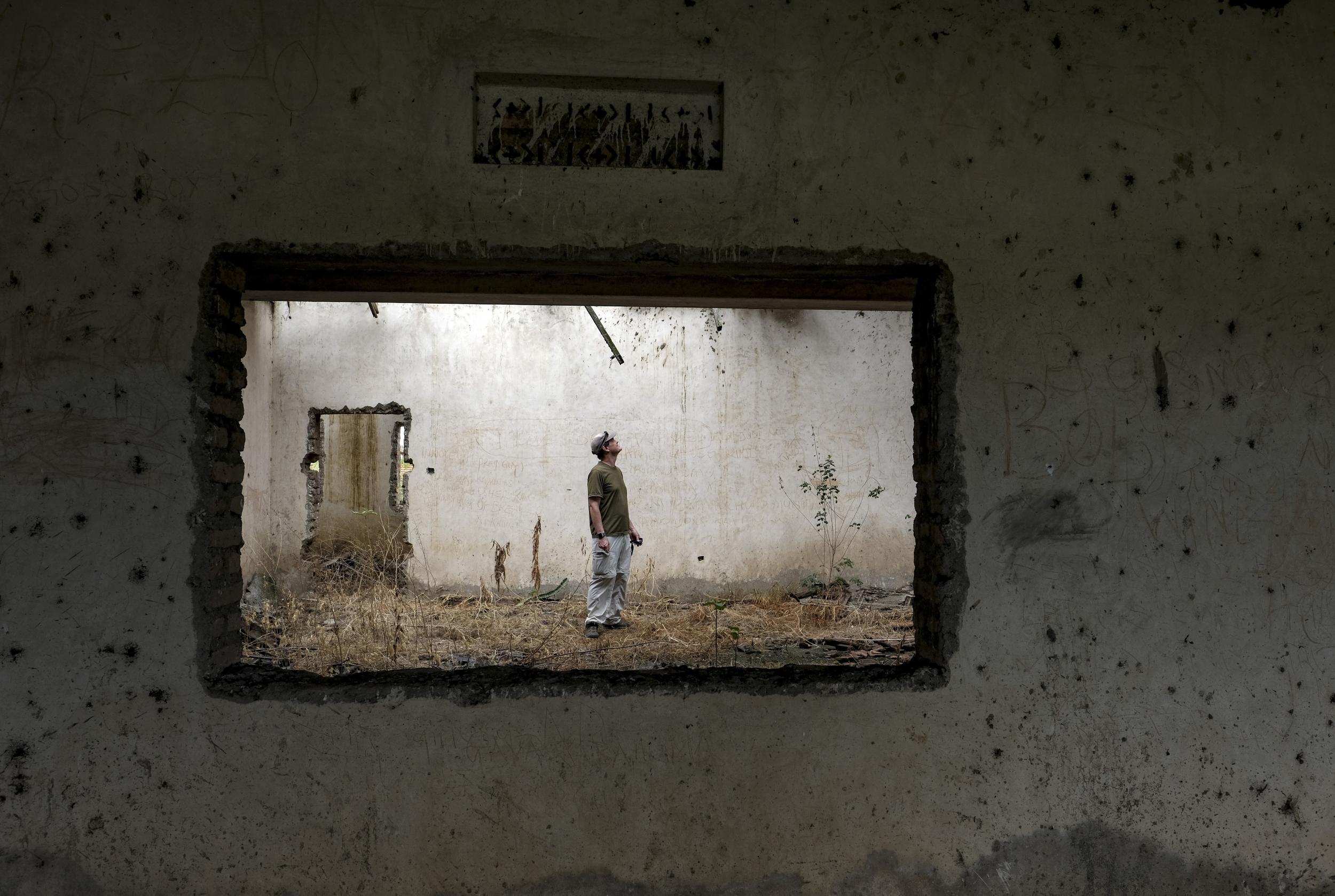 Jonathan Towner searches for bats in an abandoned building in Queen Elizabeth National Park (The Washington Post)