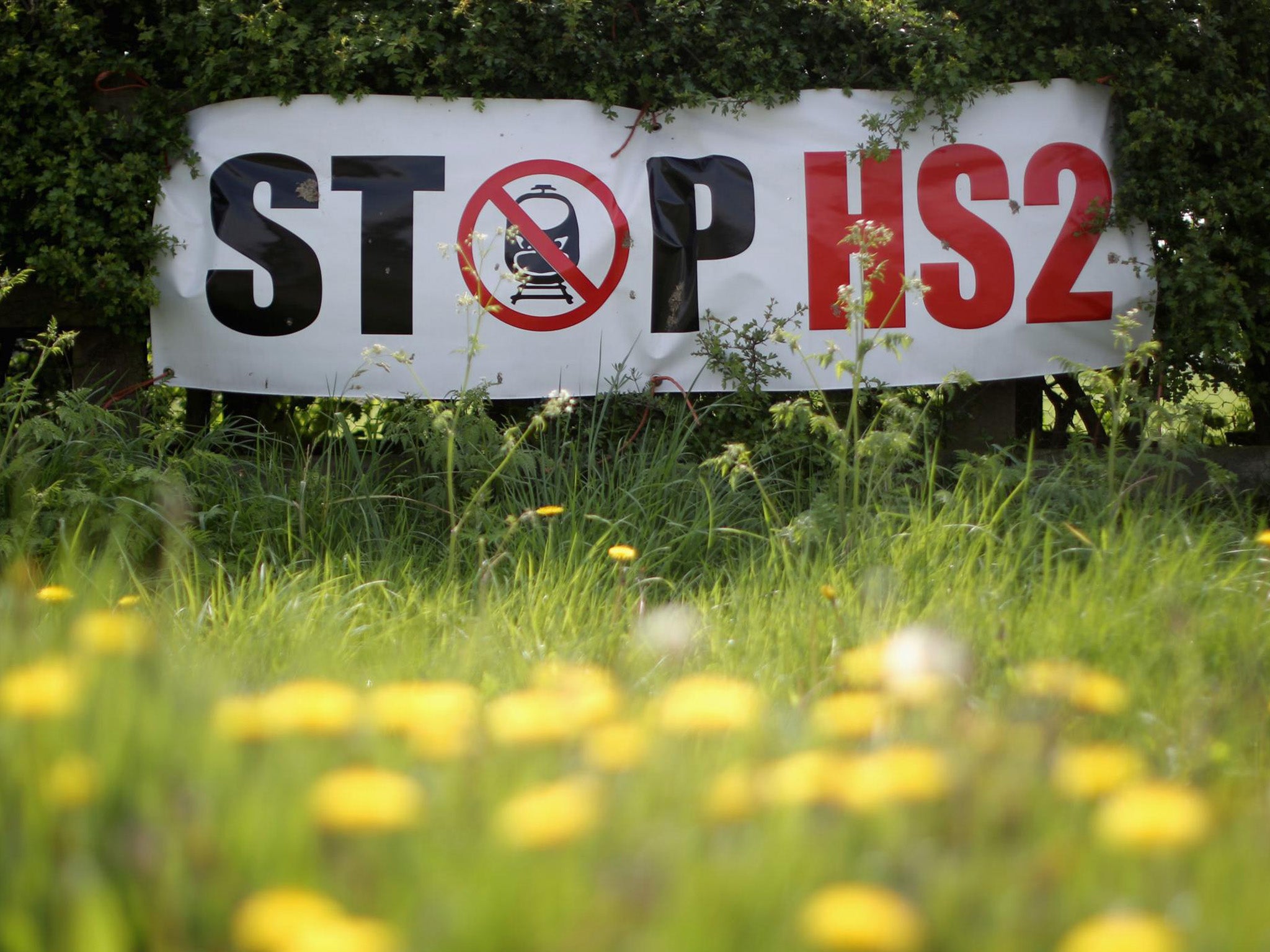 Protesters' posters mark the point where the proposed route of HS2 line will pass through near to the village of Warburton in Cheshire