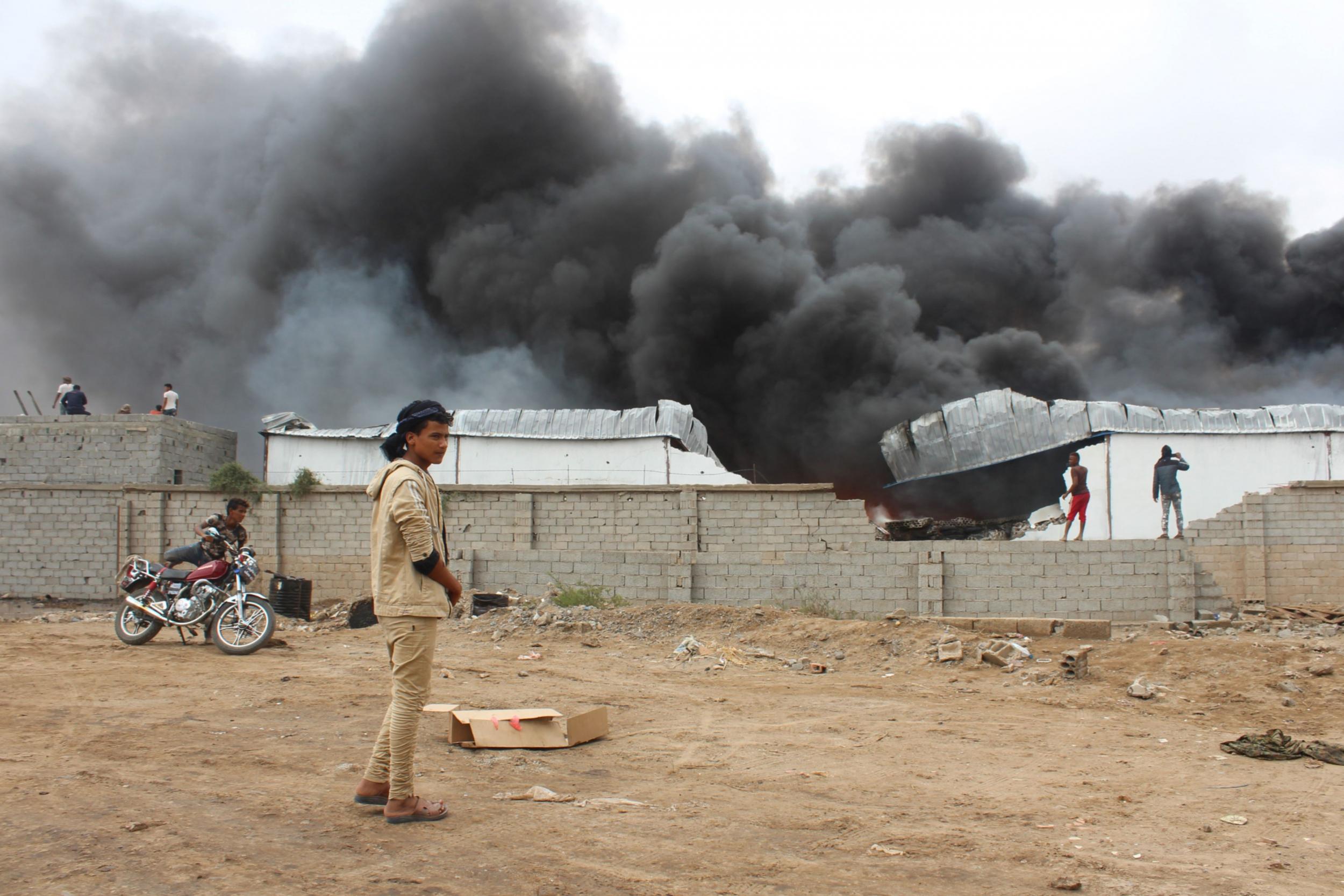 Smoke rises from inside a military camp the day after fighters from the separatist STC took control of the pro-government position in the northern Dar Saad district of Aden in January