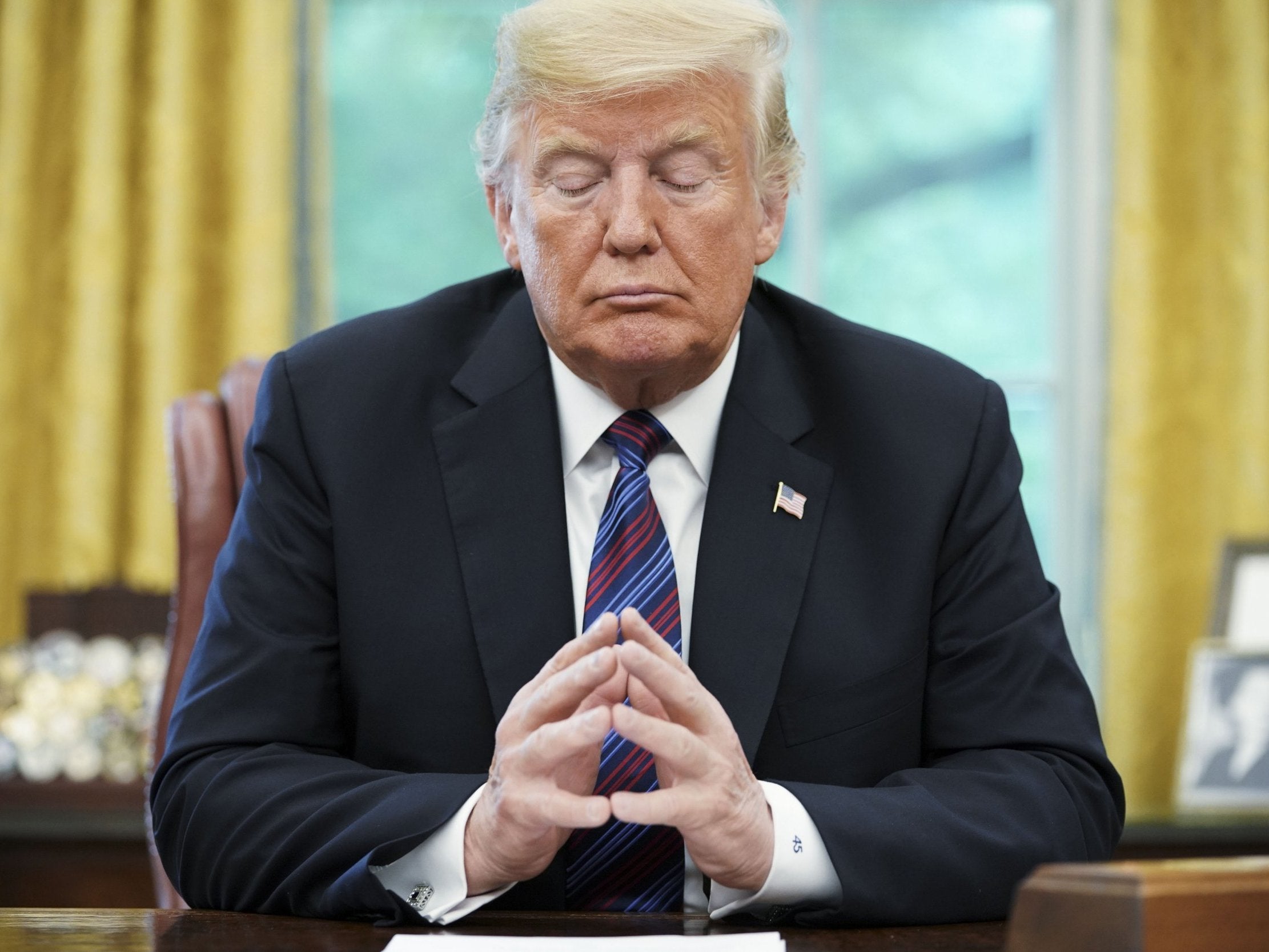 US President Donald Trump listens during a phone conversation with Mexico's President Enrique Pena Nieto on trade in the Oval Office of the White House in Washington, DC on 27 August 2018