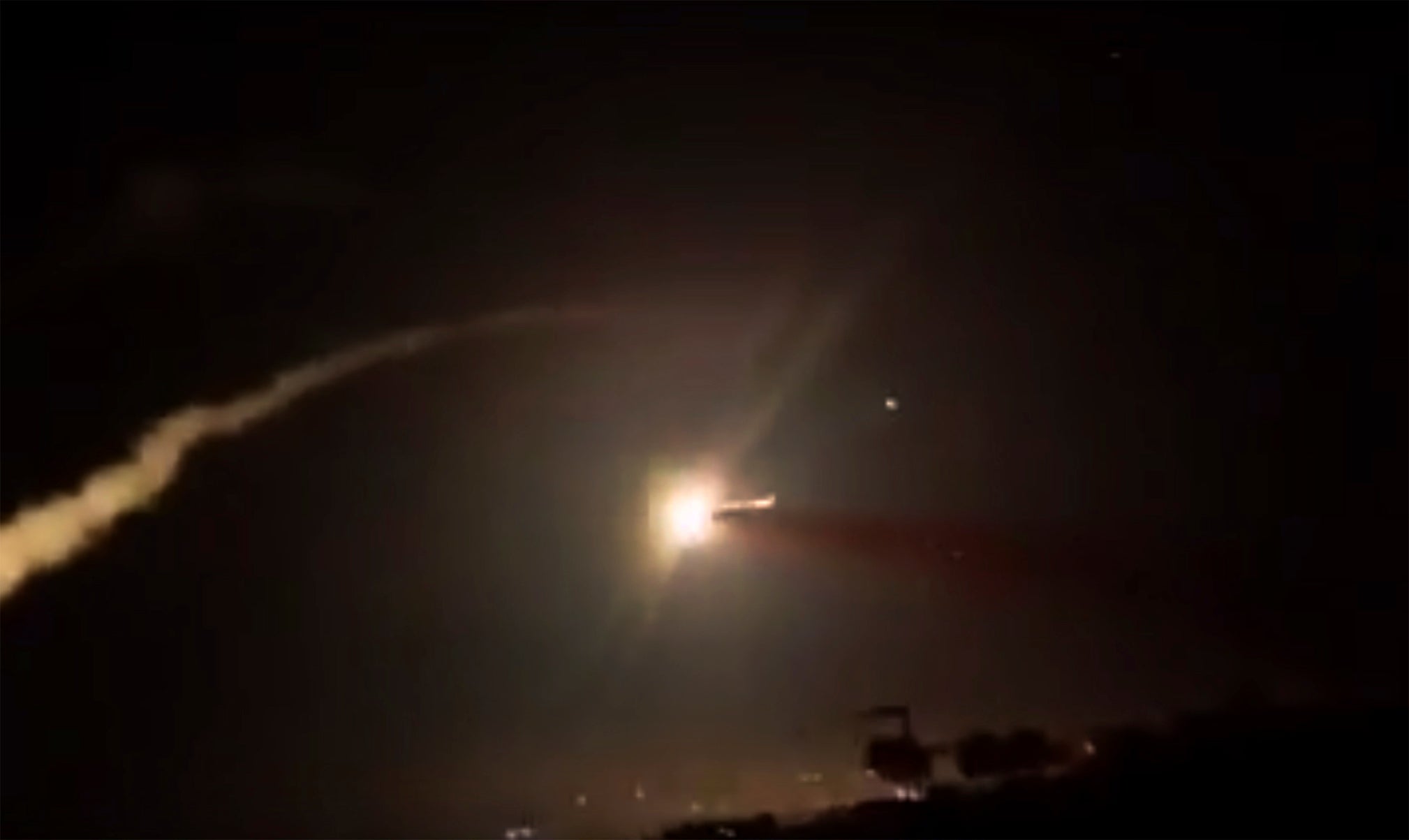 Video provided by Syrian official news agency shows missiles flying into the sky near Damascus, Syria