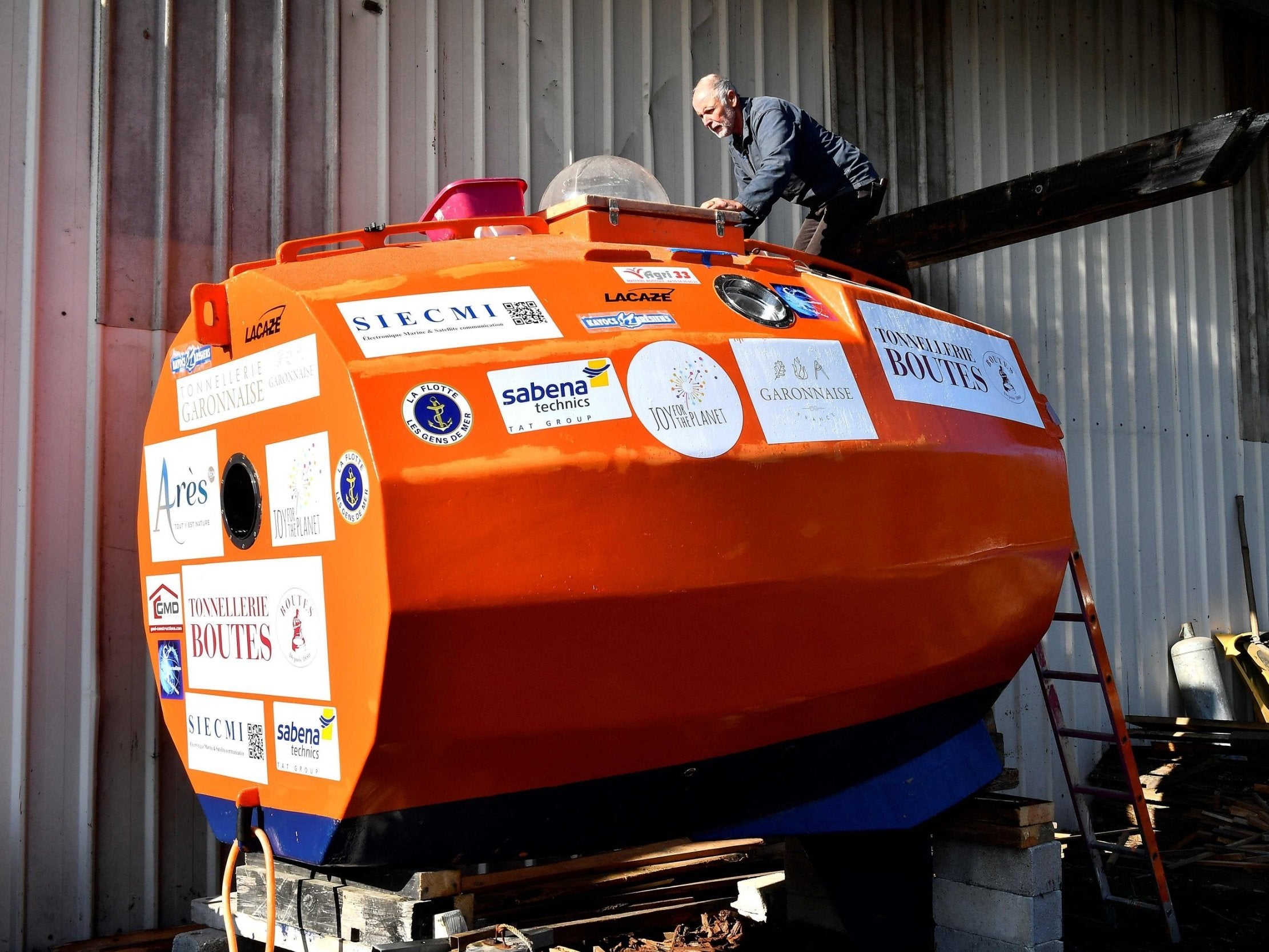 Jean-Jacques Savin works on the construction of a ship made from a barrel at the shipyard in Ares, southwestern France.