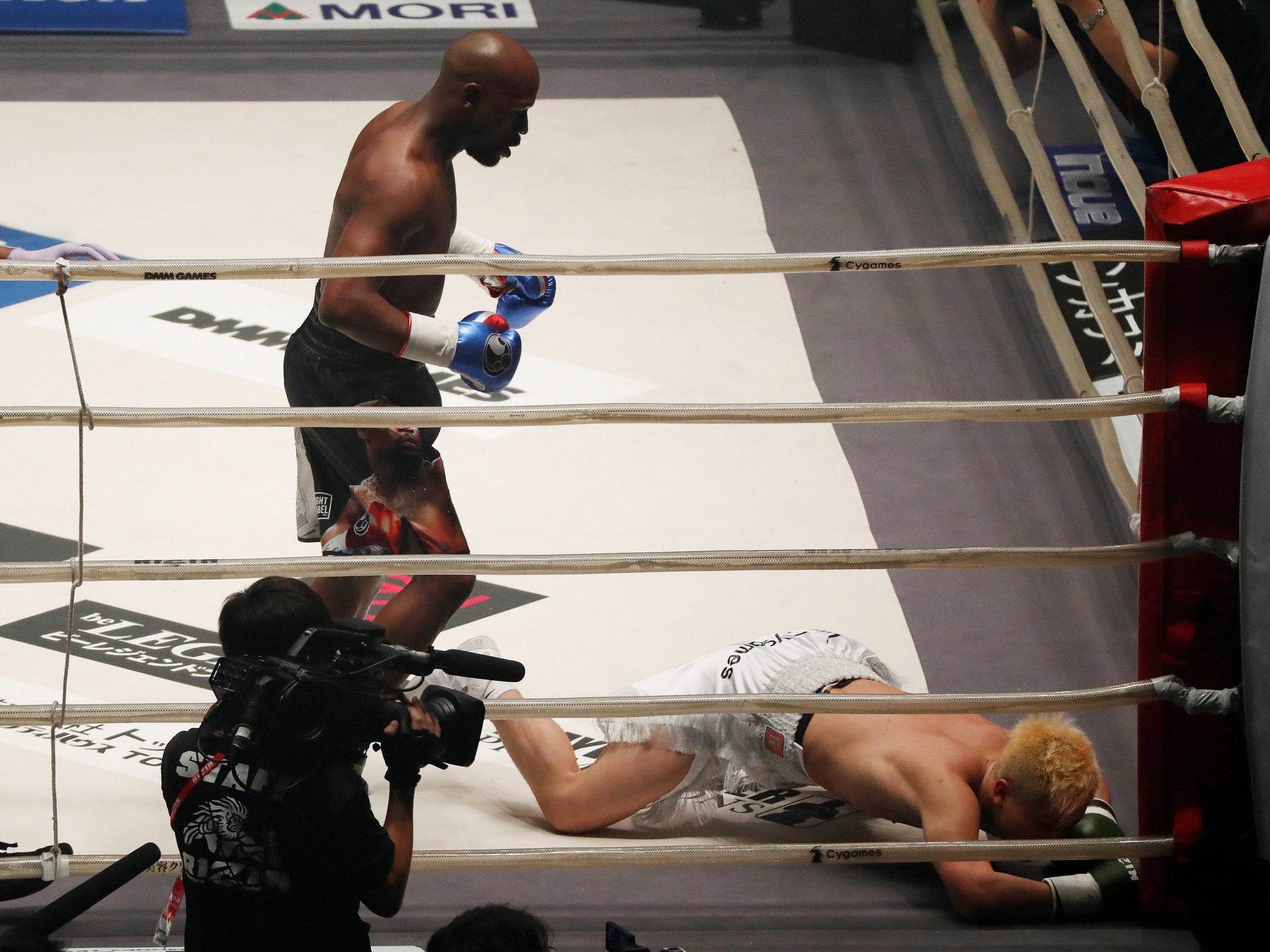 Mayweather stands over Nasukawa after knocking him down