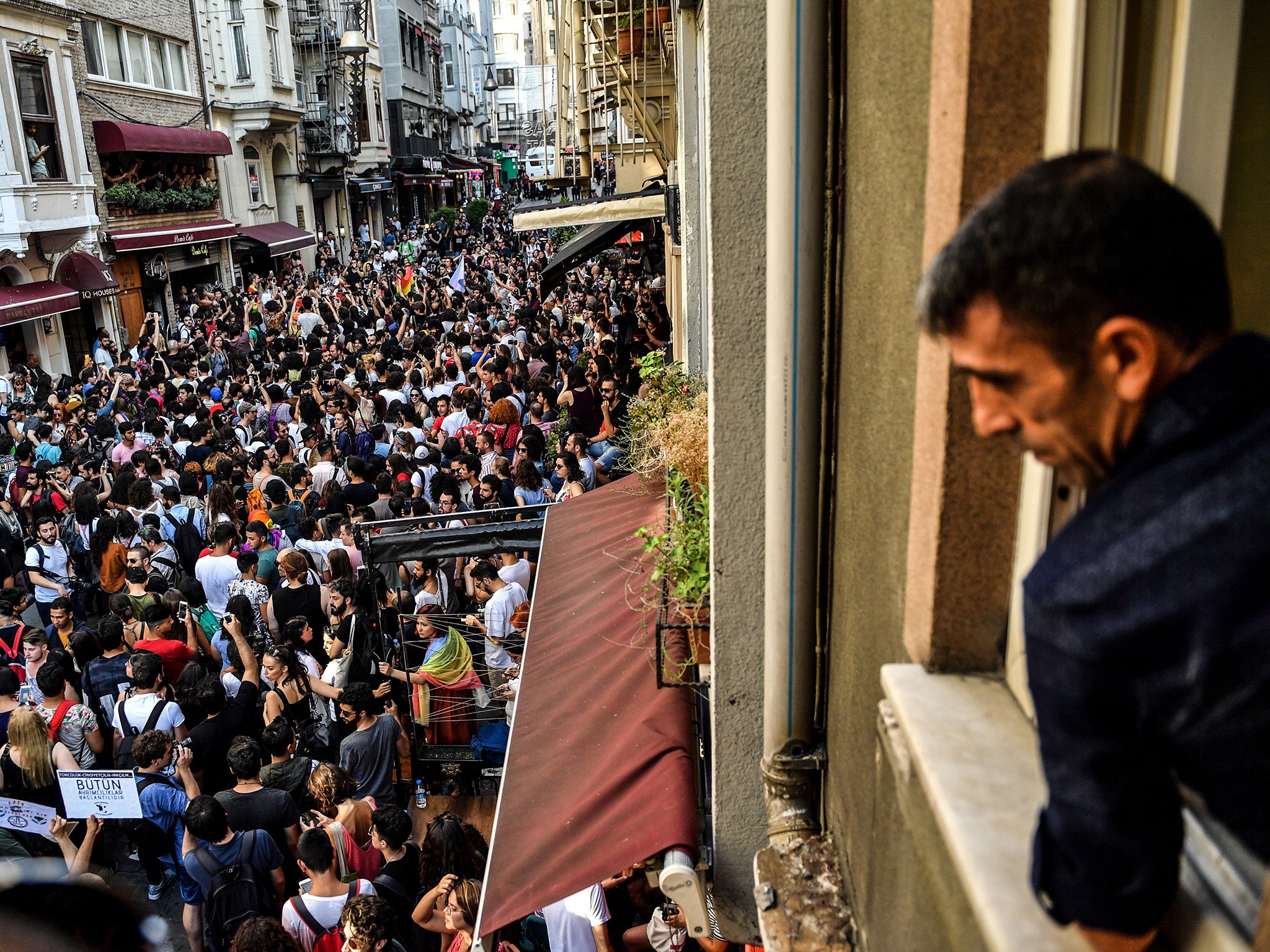 A man looks on as LGBT+ rights activists take part in a march (AFP/Getty)