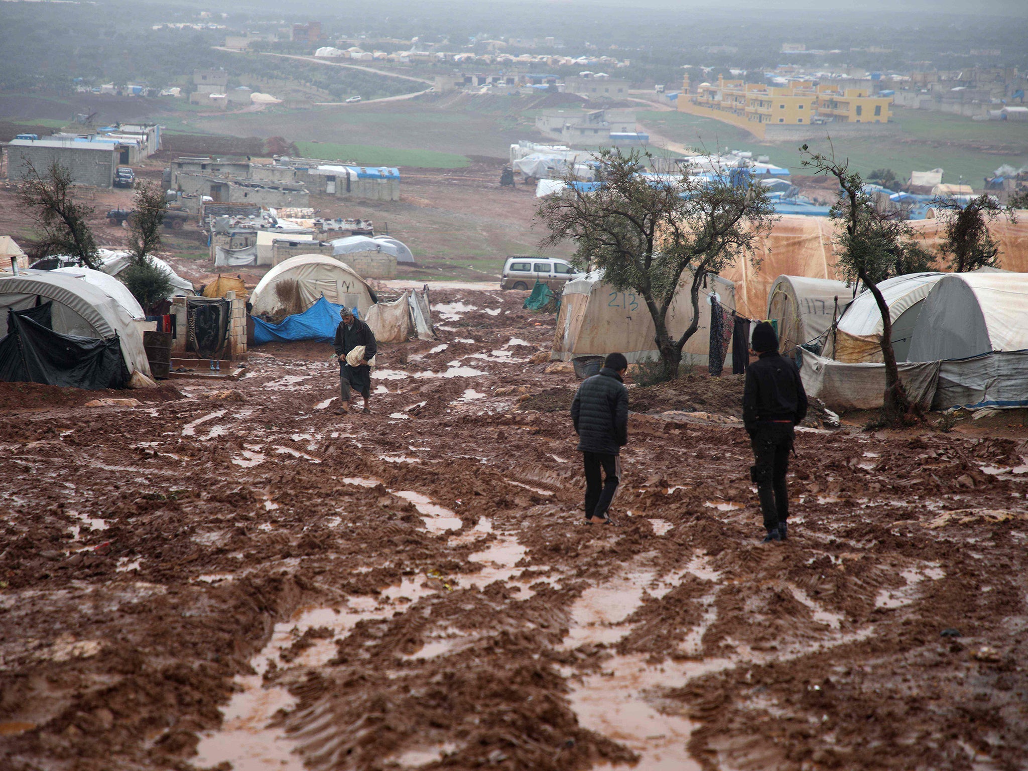 Displaced Syrians at a flooded camp near Kah, in the Idlib province in December