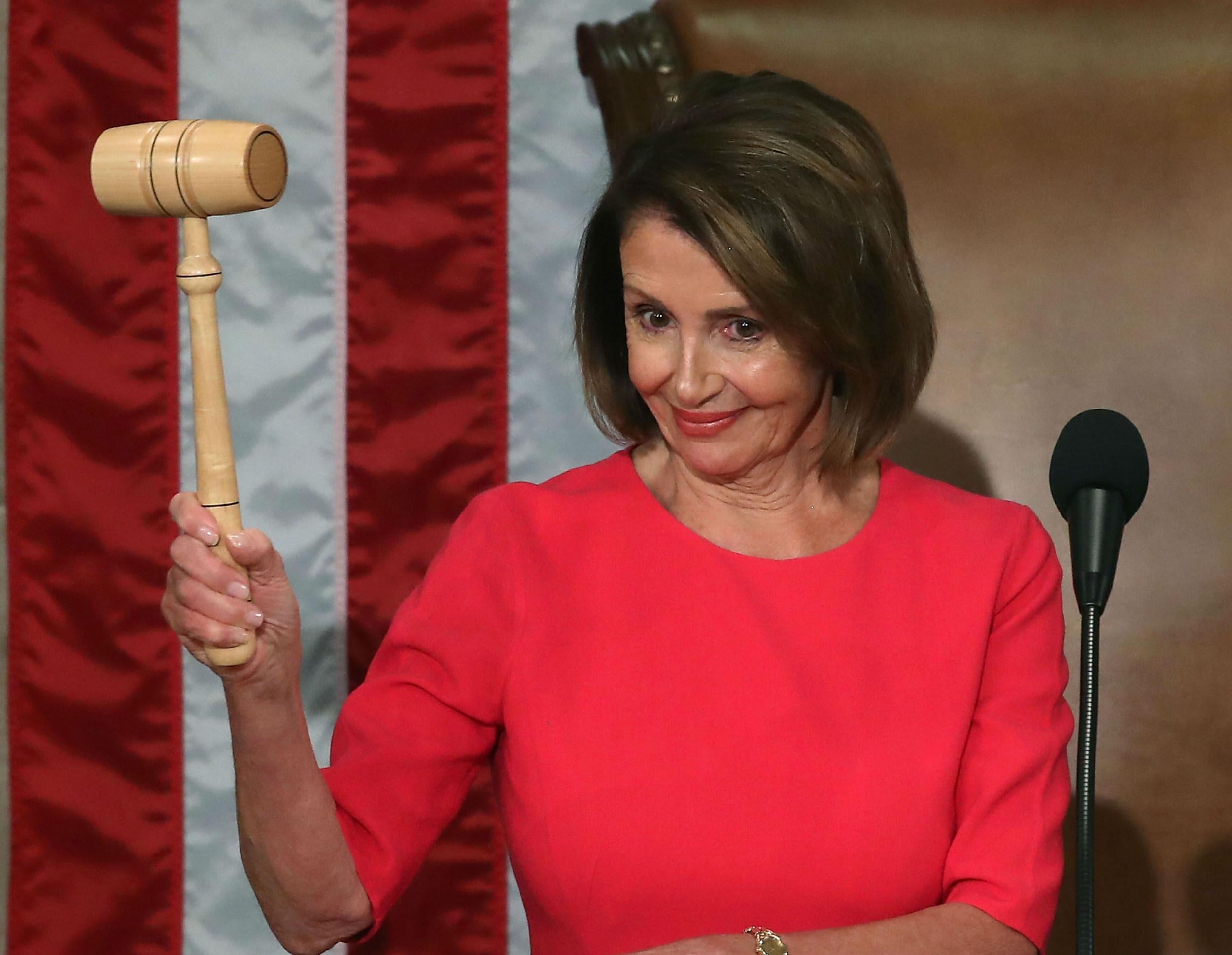 Nancy Pelosi poses with her gavel after being sworn-in as Speaker for a second time on 3 January