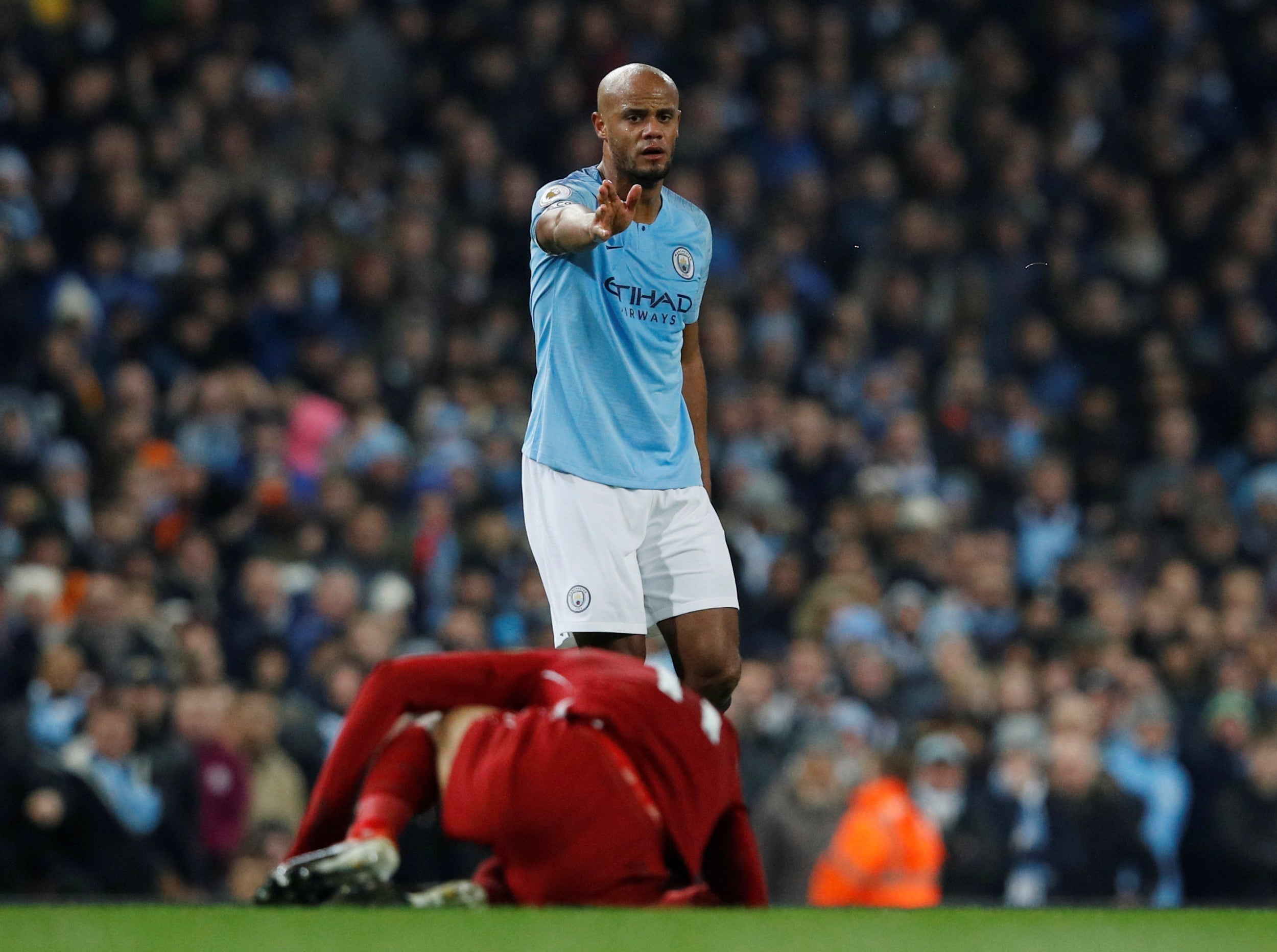 Kompany escaped a red card for a reckless slide tackle on Mohamed Salah (Reuters)