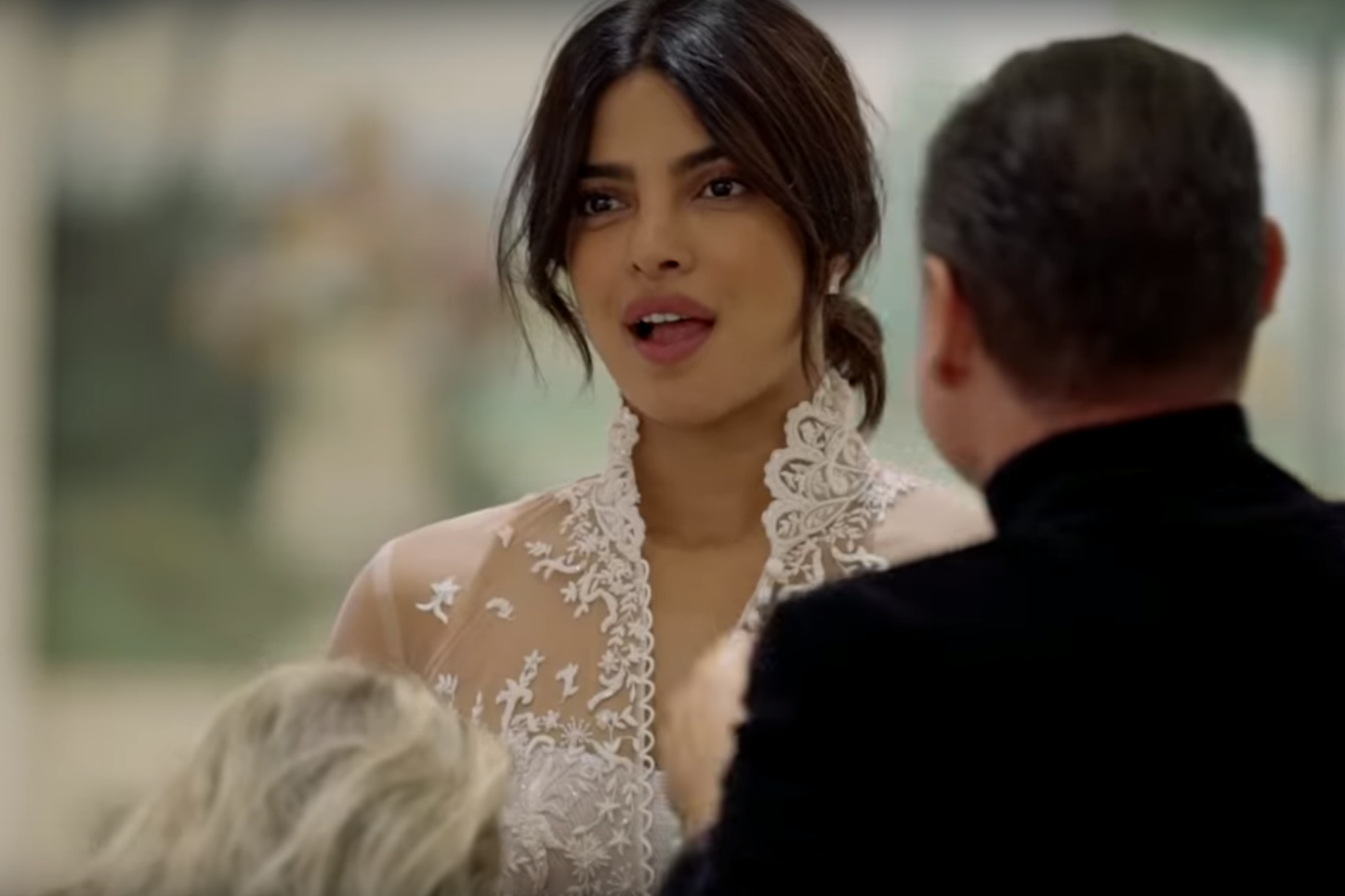 Chopra reacts with amazement as she looks at her reflection during a wedding dress fitting in Paris