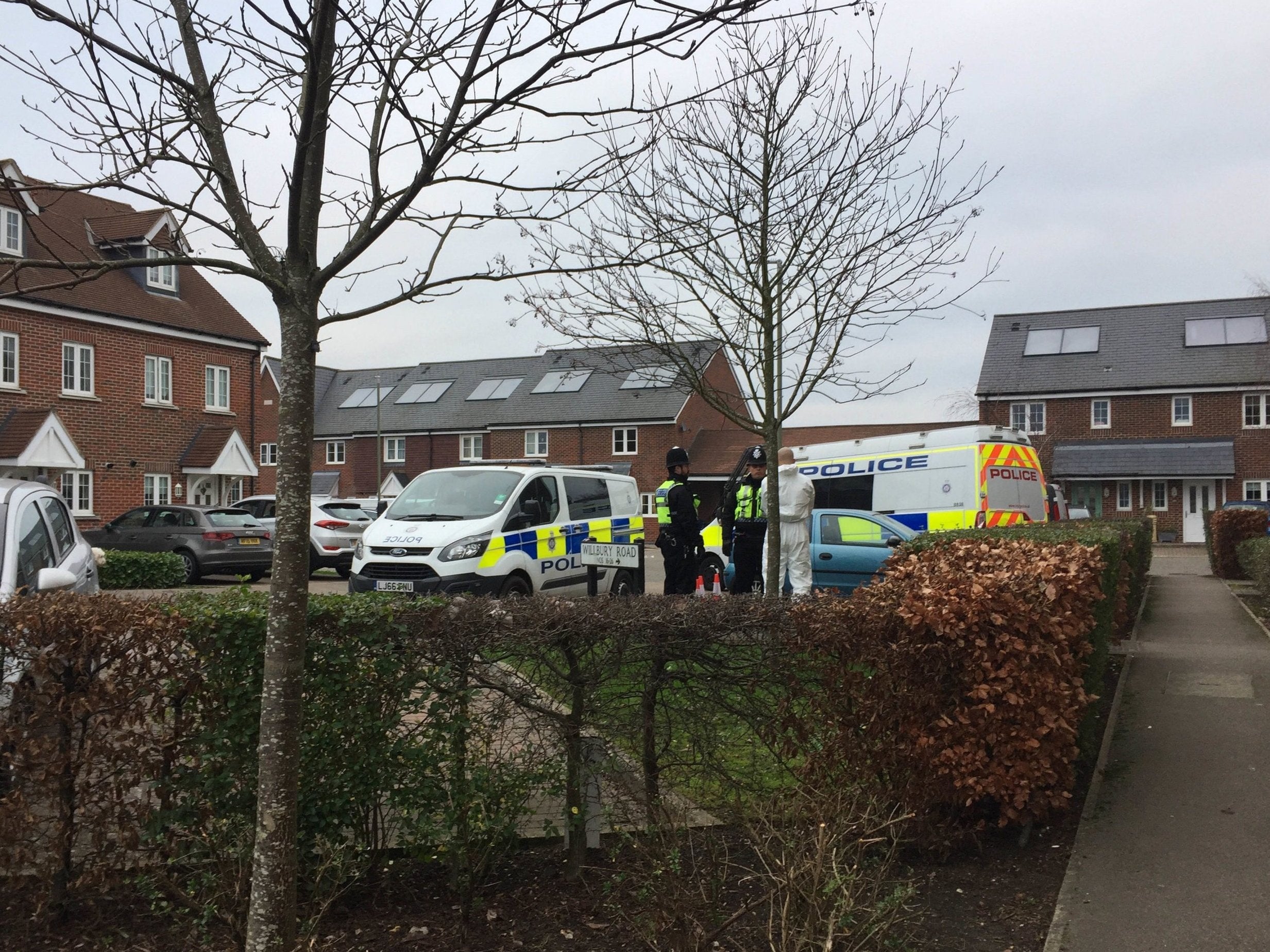 Police outside an address in Farnham where the murder suspect was detained