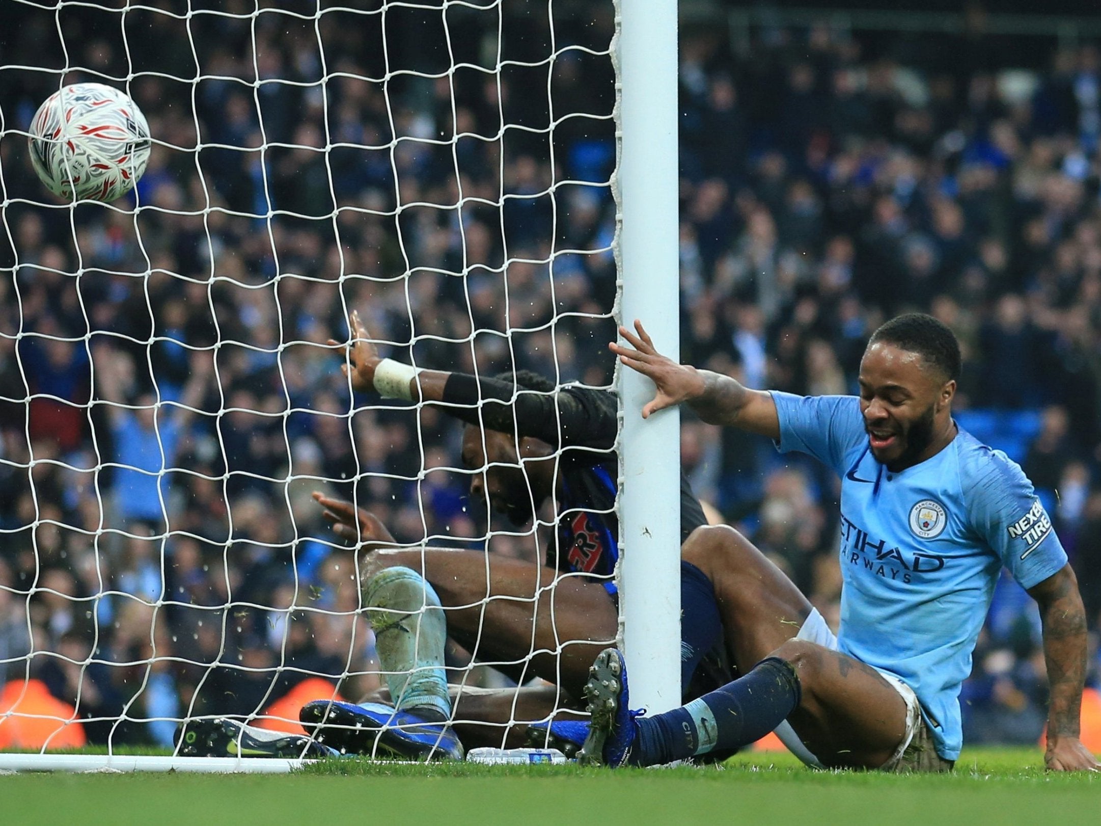 Raheem Sterling bundles the ball into the back of the net to open the scoring