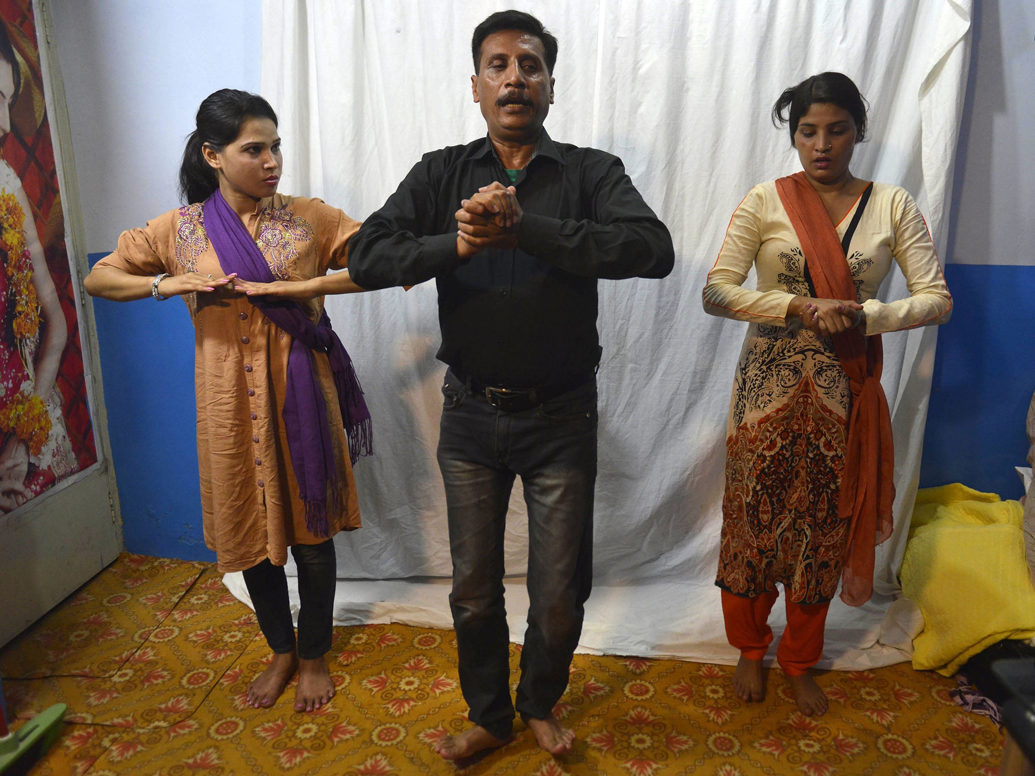 Rashid Bhatti (centre), a dance instructor in Lahore, teaches students nautch dance steps at his dance academy