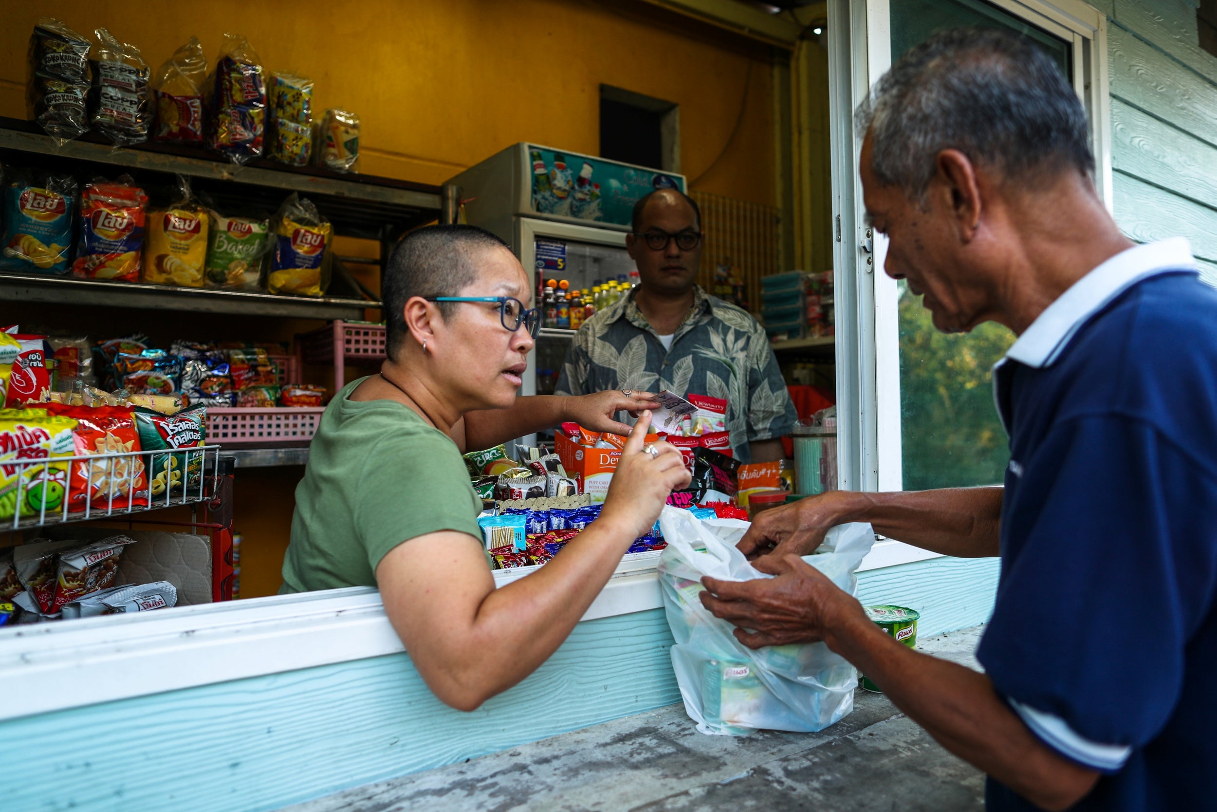 Boodsabann Chanthawong works with her husband at her stall near her house, days after she ended her novice monkhood