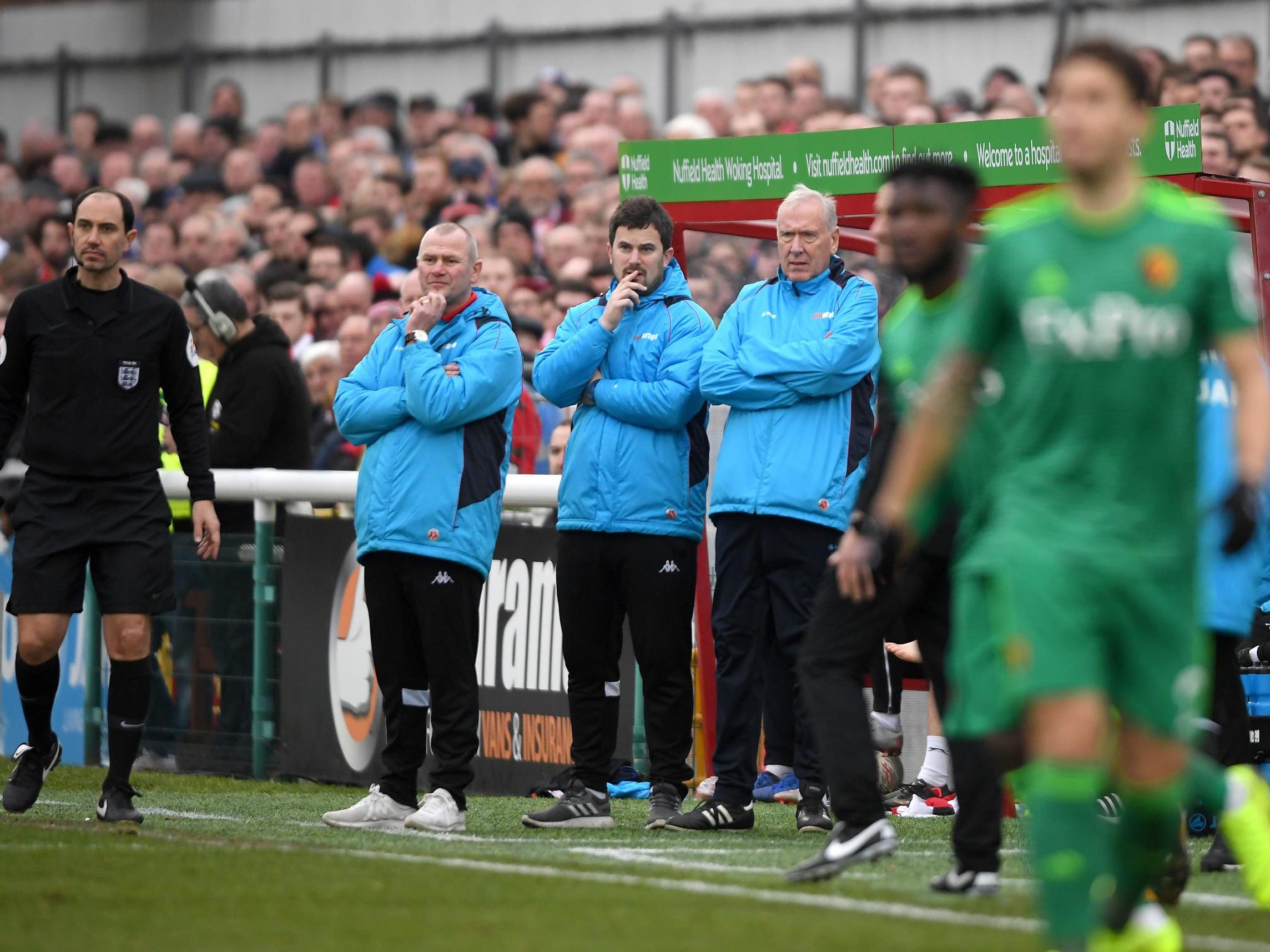 Alan Dowson (far left) looks on as his Woking side goes up against Watford