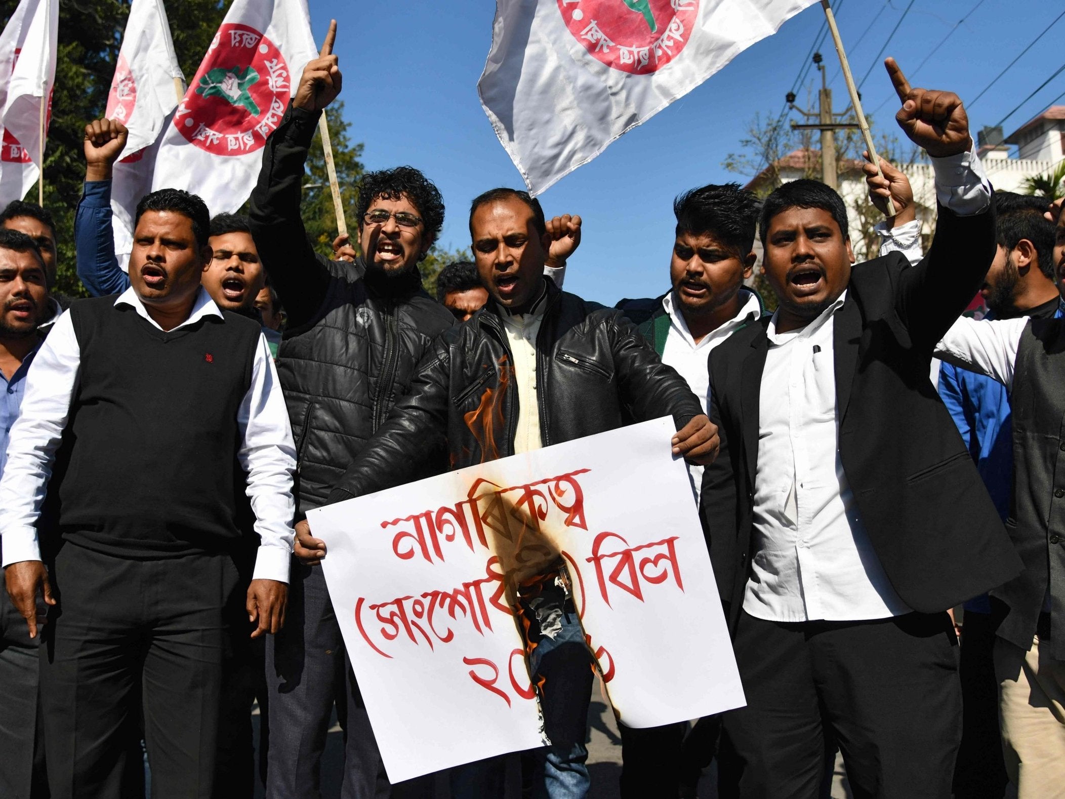 Activists of the All Assam Students' Union (AASU) burn a dummy copy of Citizenship Amendment Bill during a protest in Guwahati