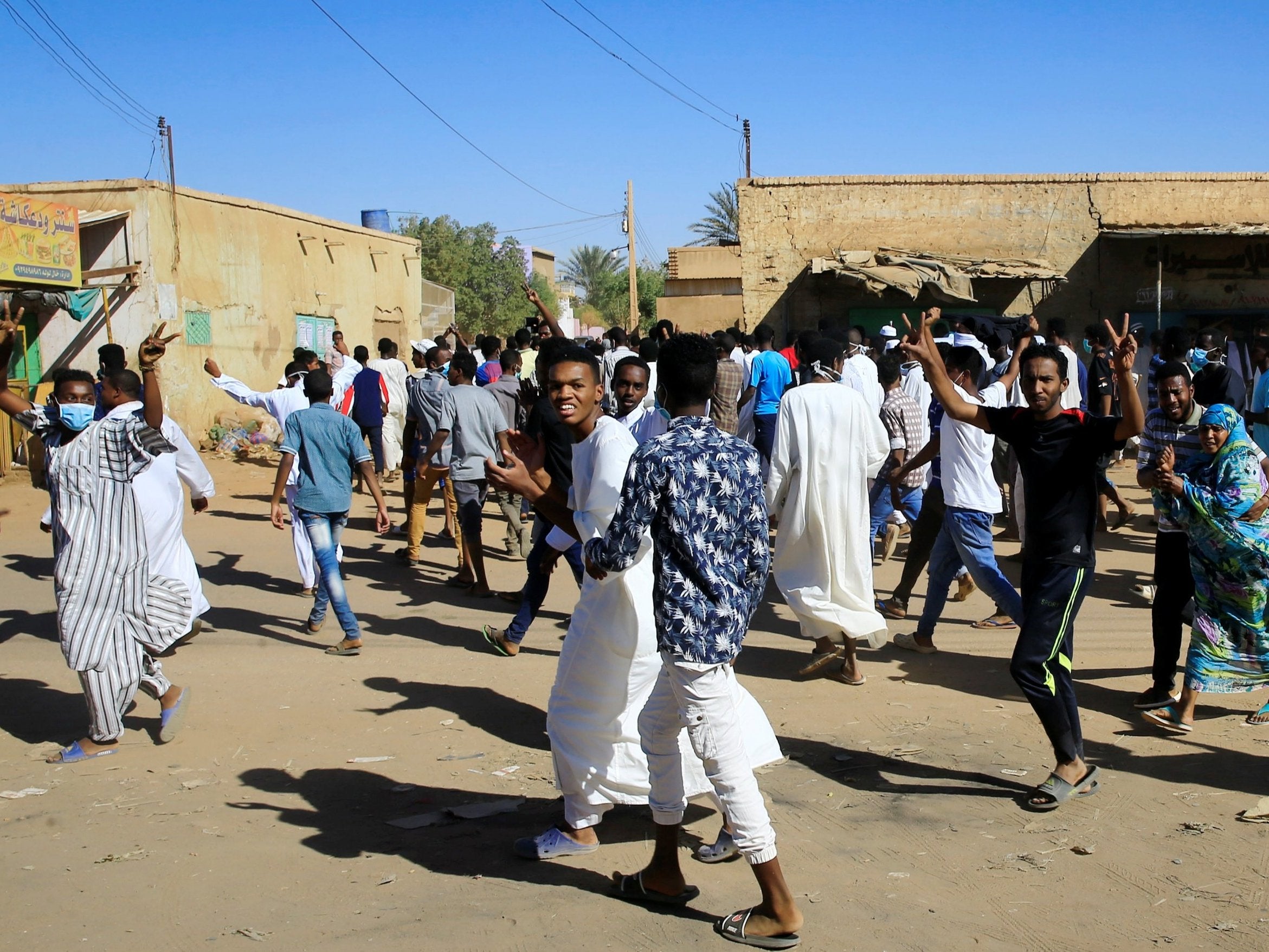 Demonstrators march along the street during anti-government rallies after Friday prayers in Khartoum