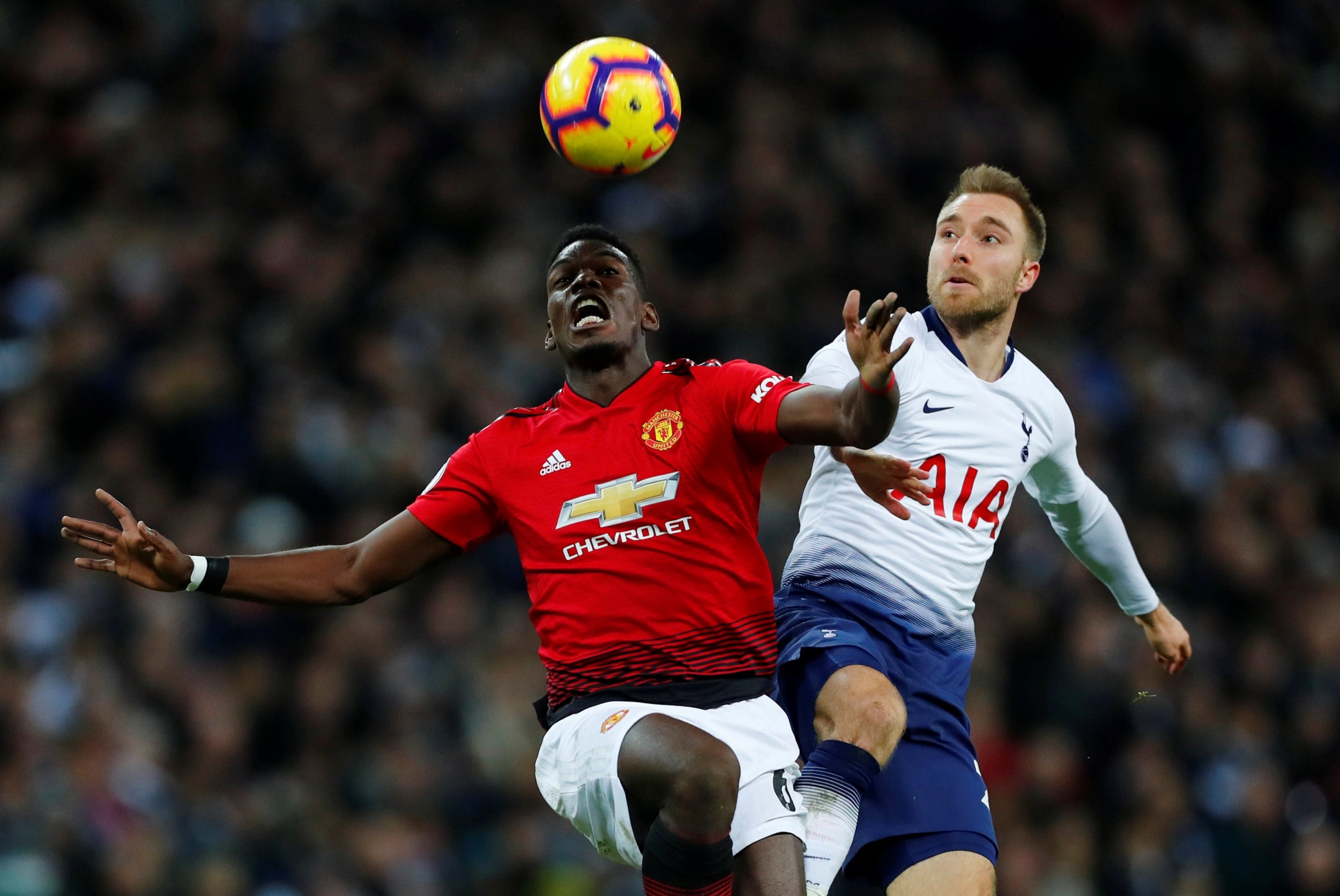 Paul Pogba and Christian Eriksen tussle for possession