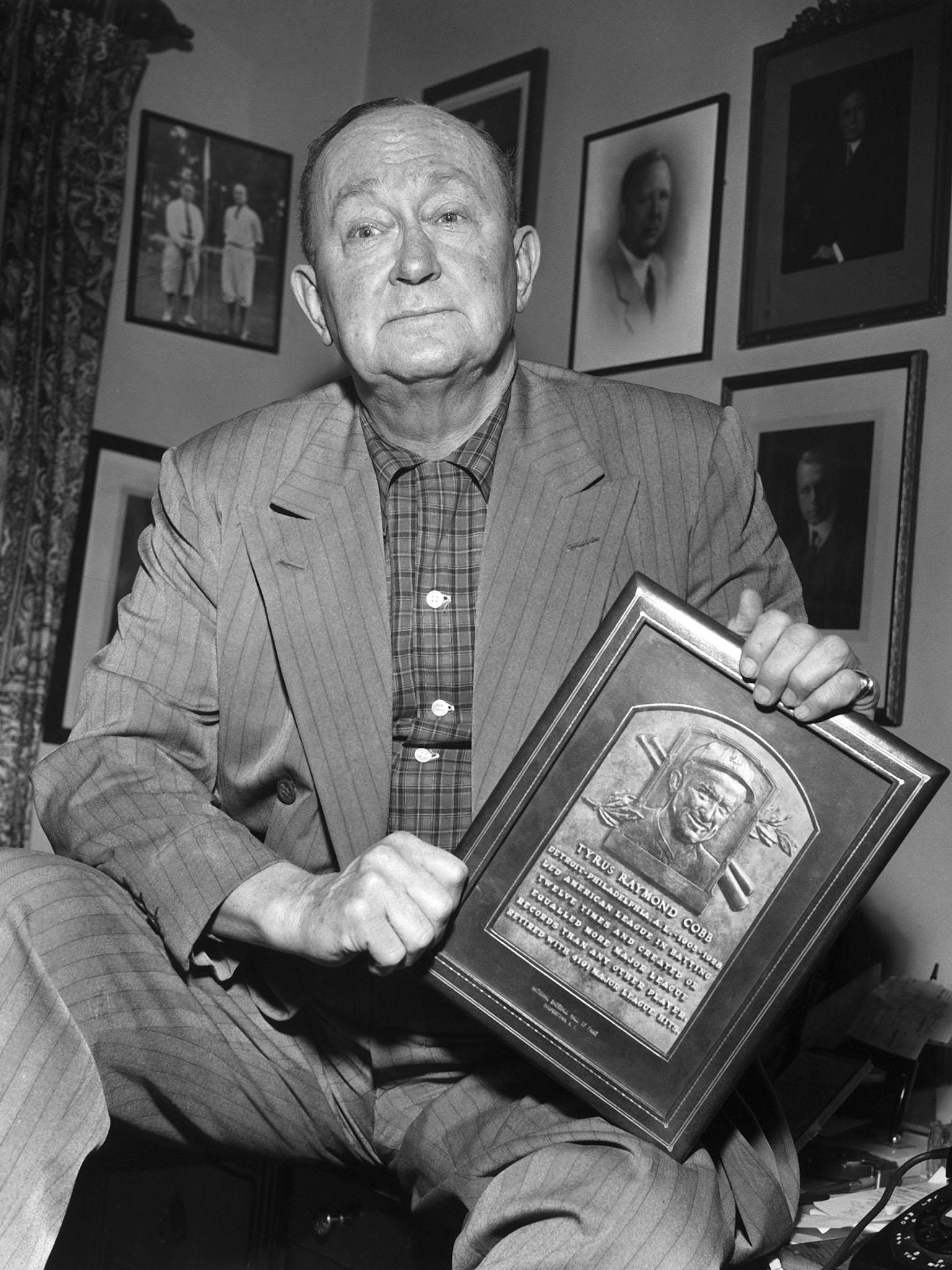 Ty Cobb holds a replica of his Hall of Fame plaque in 1957 (Rex)