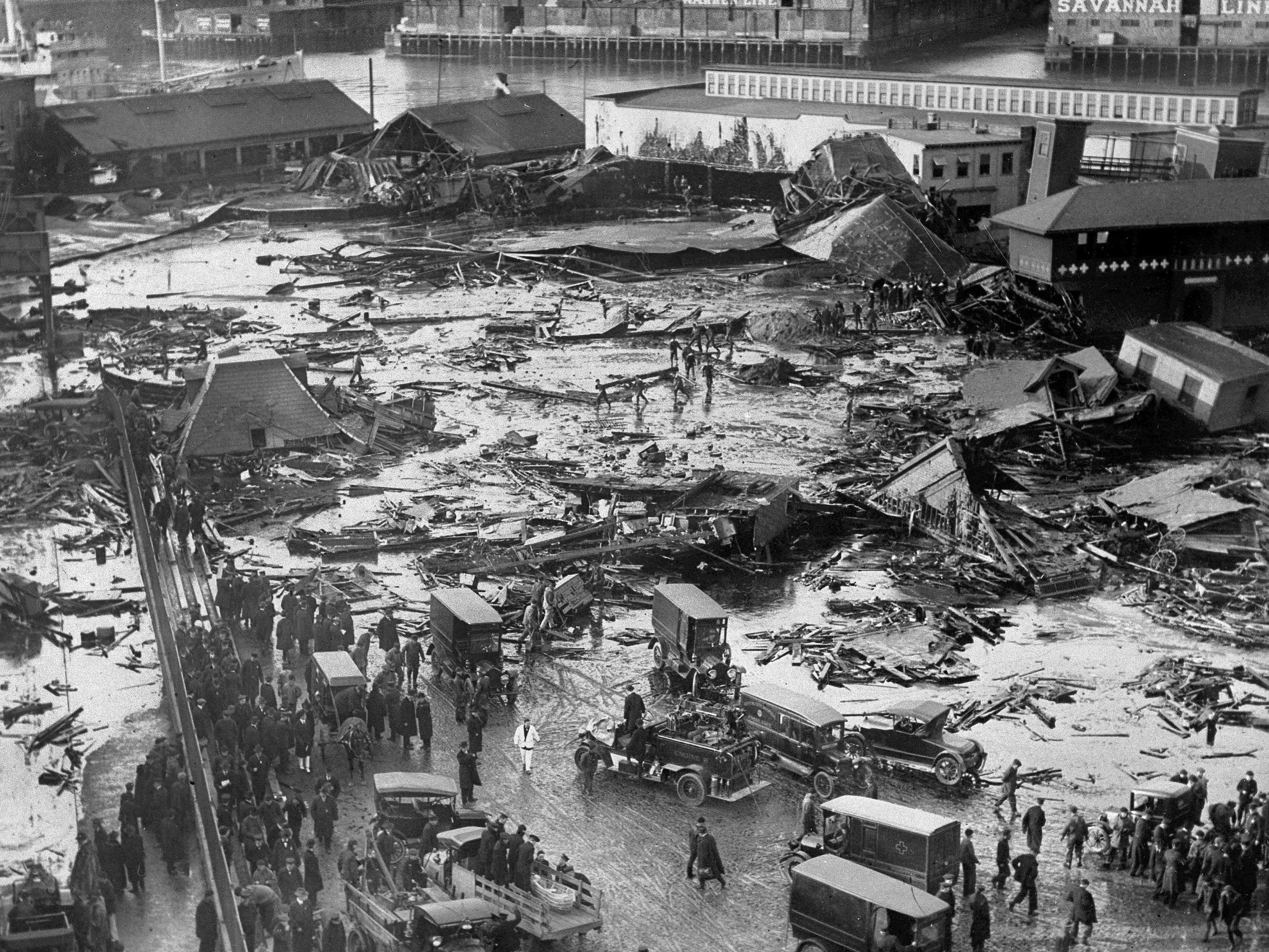 In this 15 January 1919 file photo, the ruins of tanks containing more than two million gallons of molasses lie in a heap after erupting along the waterfront in Boston's North End neighbourhood. Several buildings were flattened in the disaster, which killed 21 people and injured 150 others.