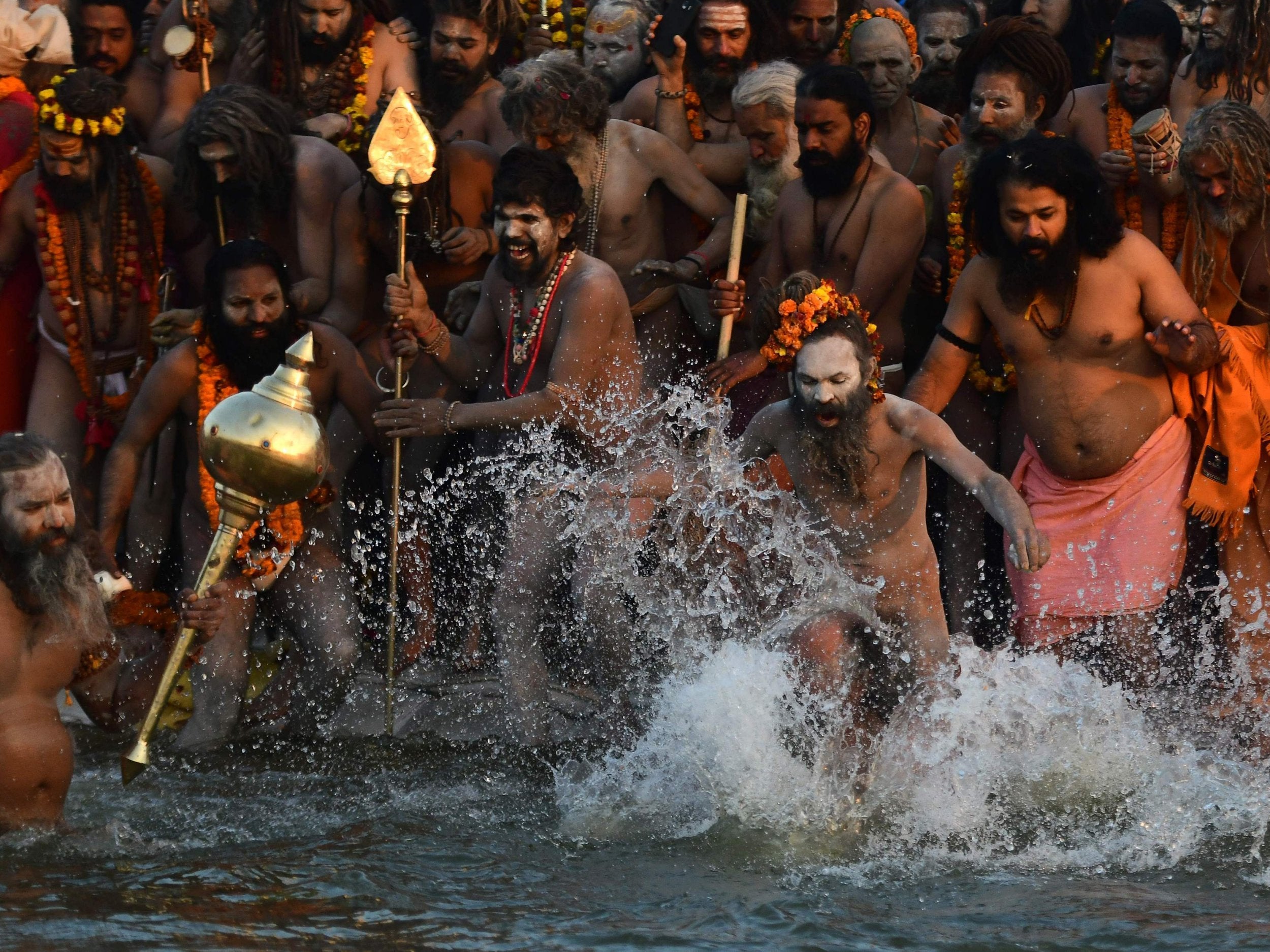 Indian sadhus take a dip at the holy Sangam – the confluence of the Ganges, Yamuna and mythical Saraswati rivers