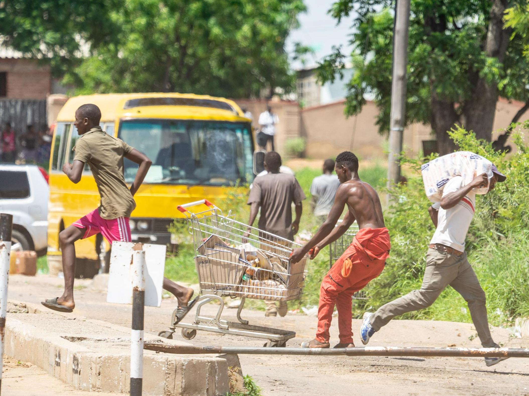 People run with loot as protests continue in Zimbabwe