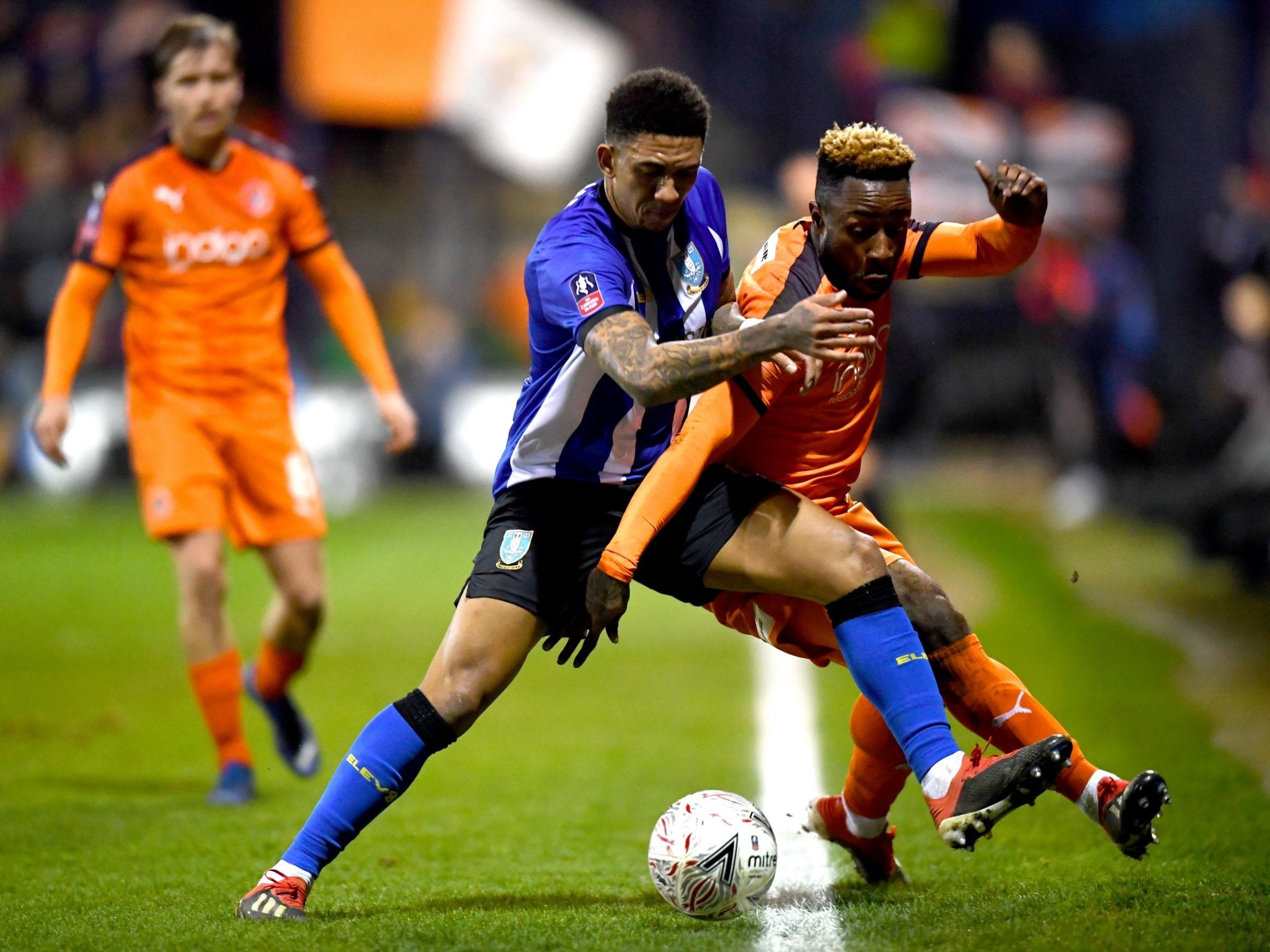 Wednesday's Liam Palmer and Kazenga LuaLua battle for the ball