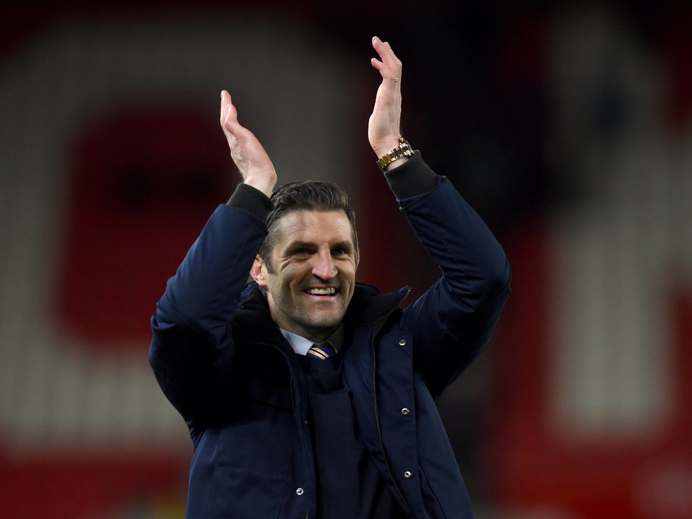 Shrewsbury Town manager Sam Ricketts celebrates with the visiting fans