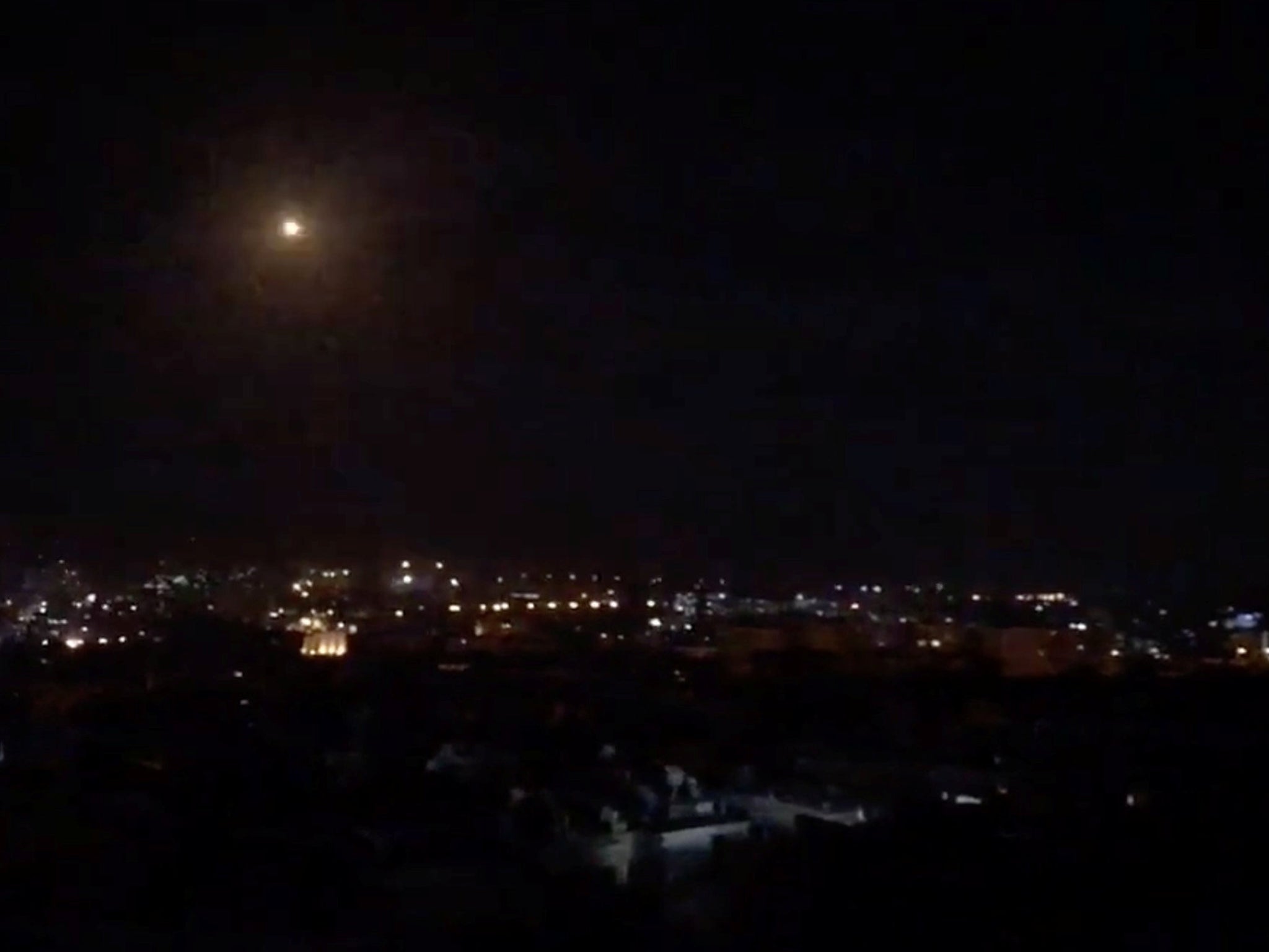 What is believed to be guided missiles are seen in the sky during what is reported to be an attack in Damascus, Syria, January 21, 2019, in this still image taken from a video obtained from social media