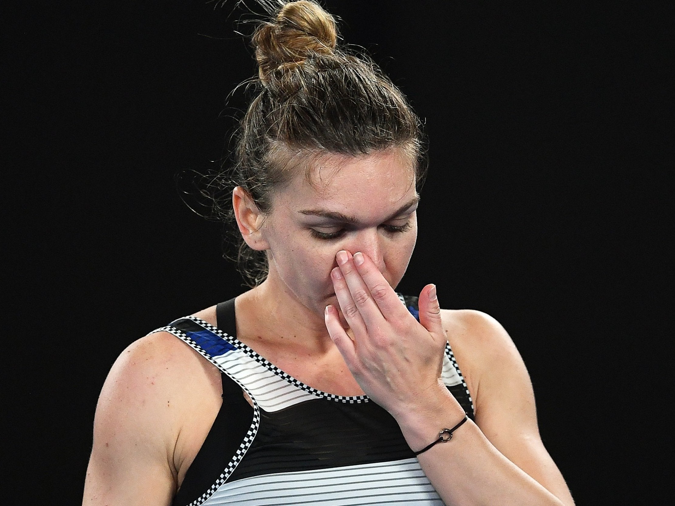 Simona Halep reacts to her fourth-round defeat