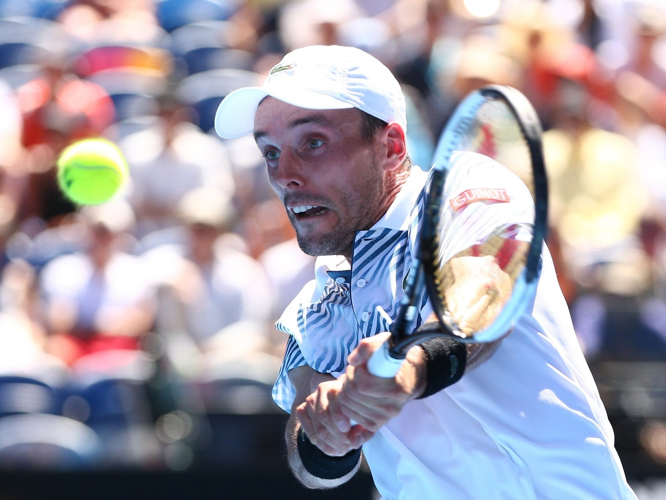 Roberto Bautista Agut plays a backhand to Stefanos Tsitsipas