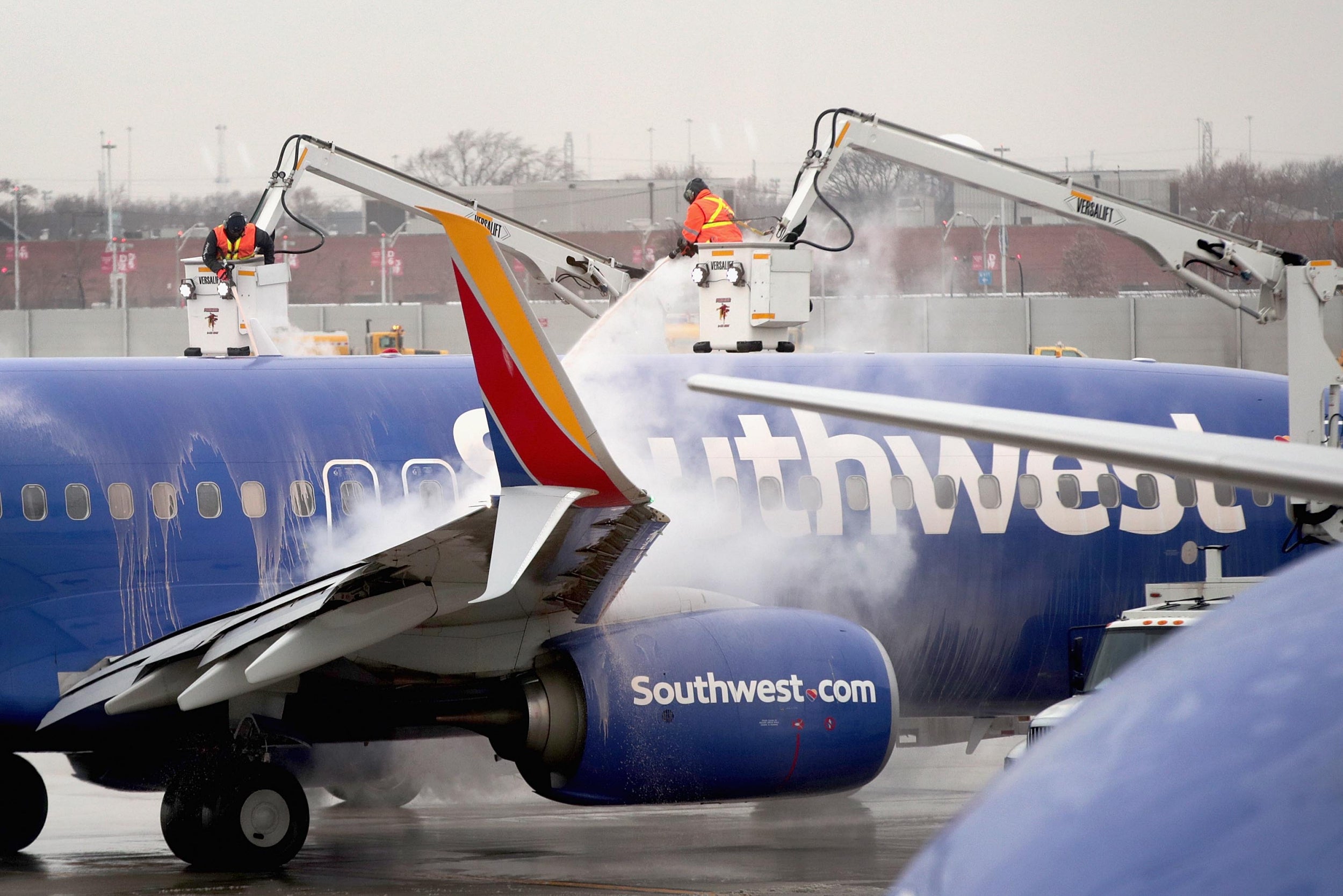 Workers deice a Southwest Airline aircraft at Midway Airport in Chicago