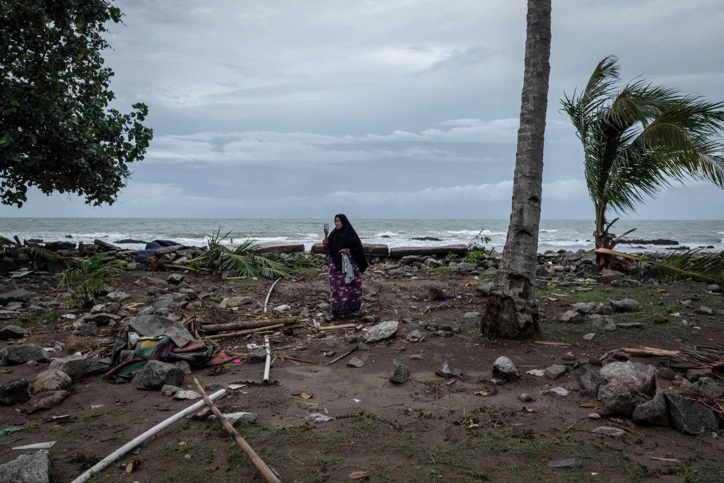 A woman taking pictures of debris with her smartphone on 24 December, 2018 in Carita, Indonesia. Over 280 people were reportedly killed after a volcano-triggered tsunami hit the coast around Indonesia's Sunda Strait