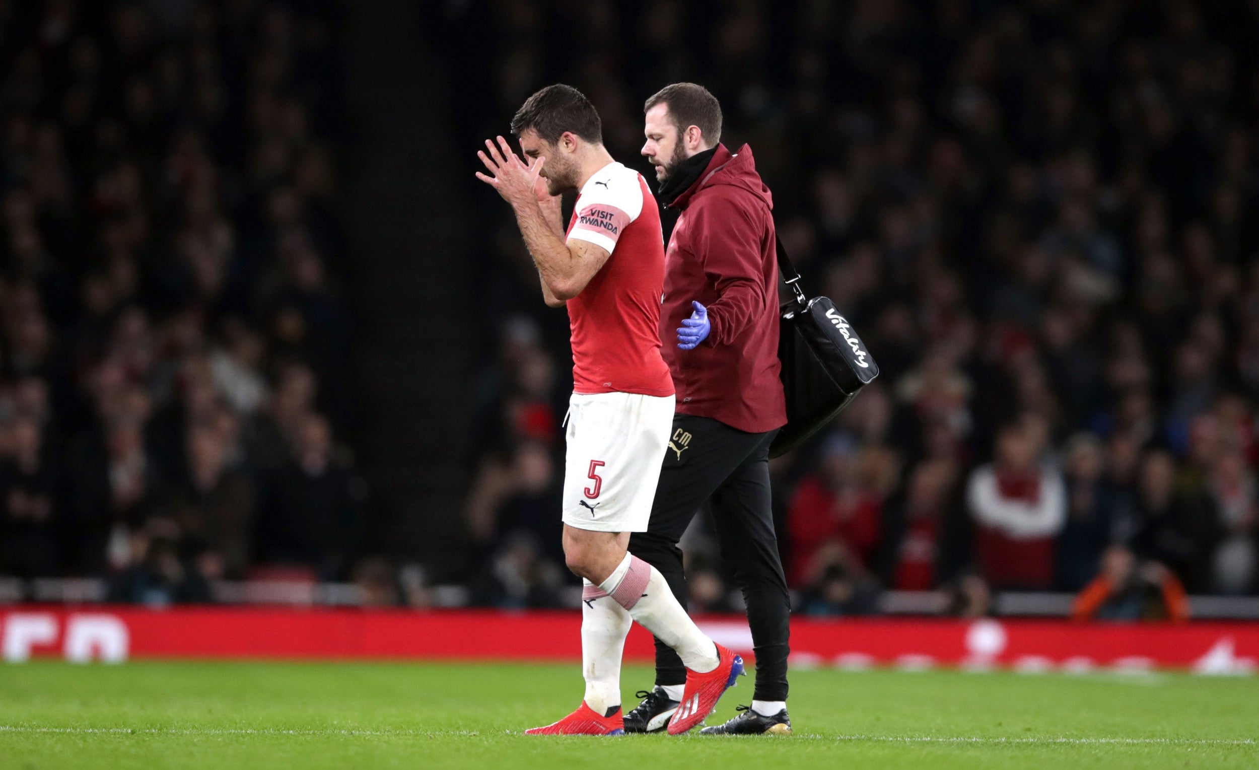 Sokratis walks off after suffering an injury vs United