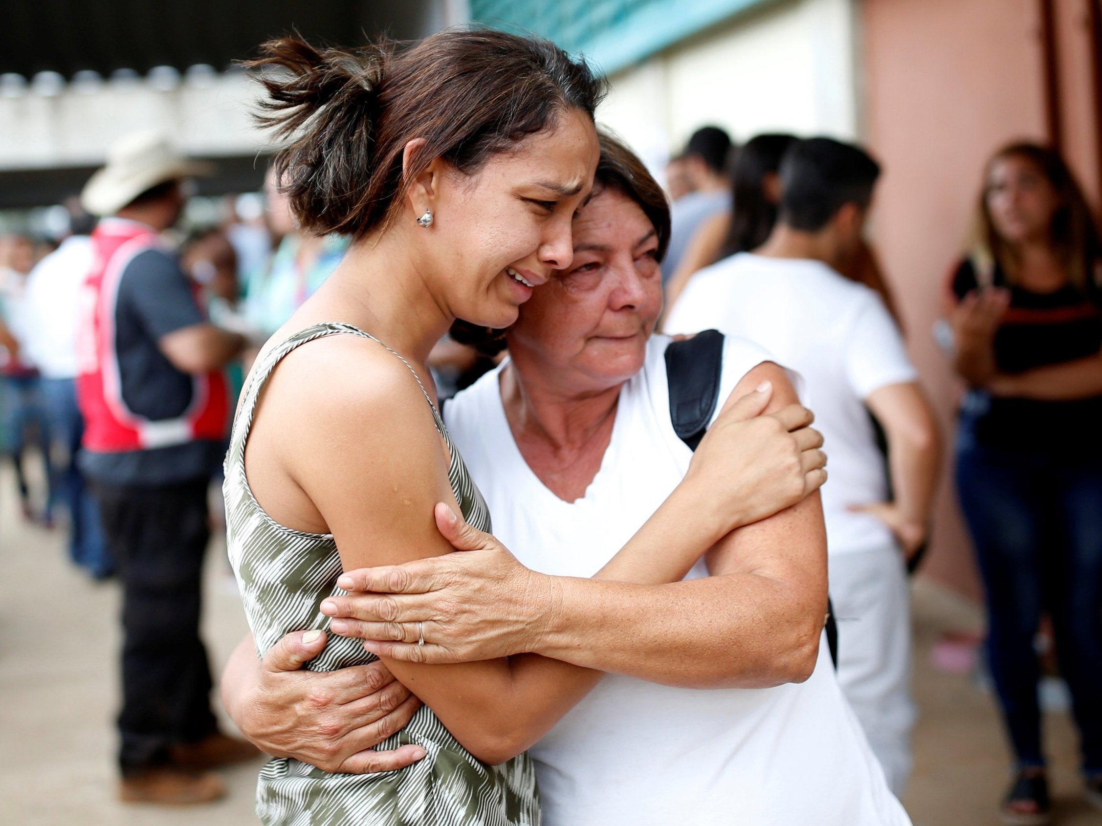 Relatives of missing people wait for news after dam disaster