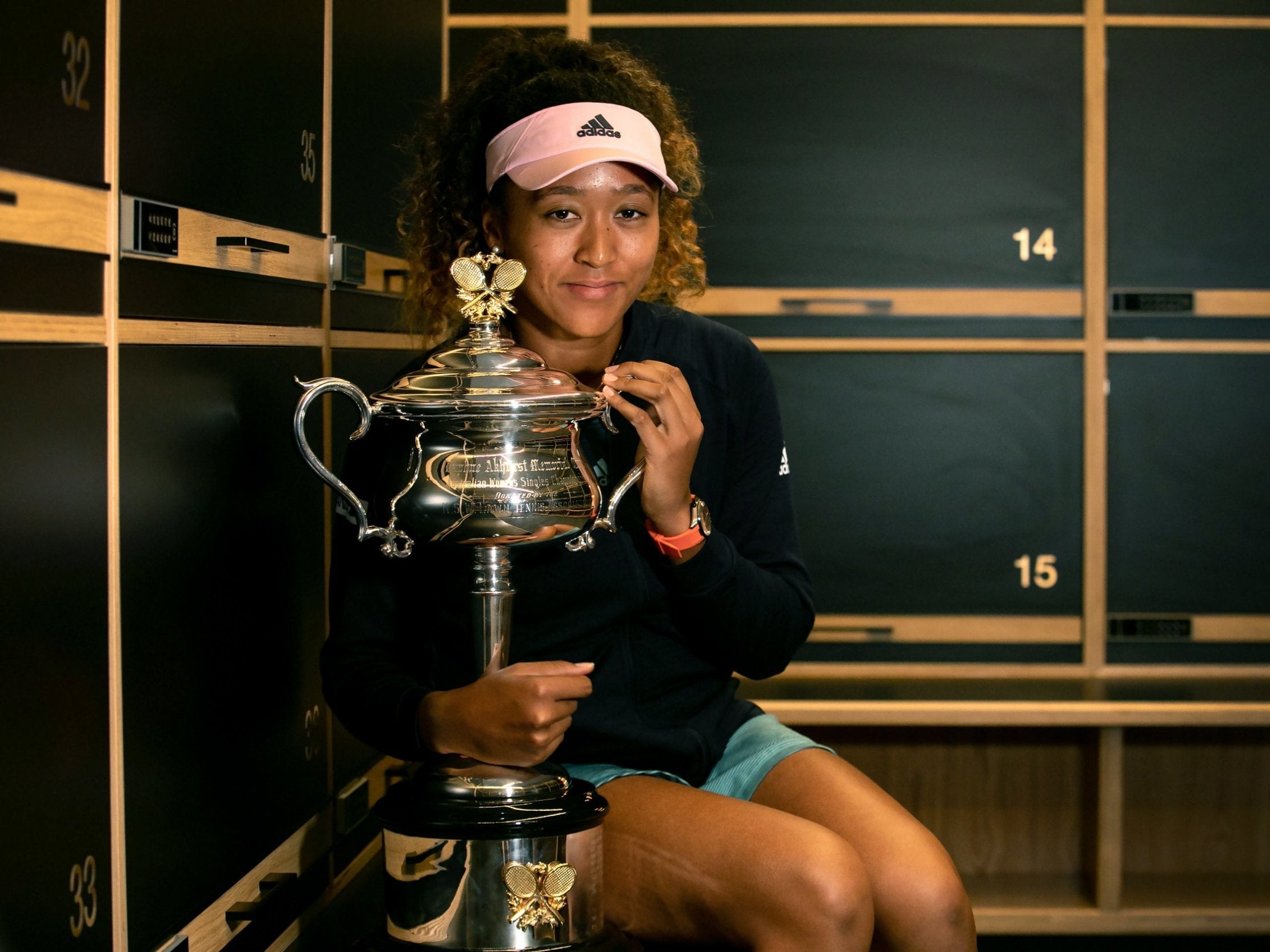 Naomi Osaka of Japan poses for photos in the locker room