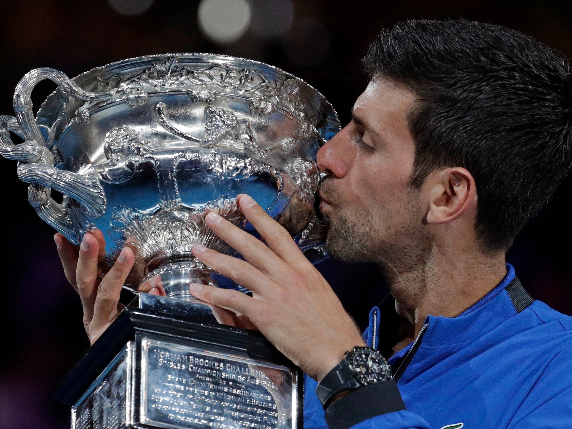 Djokovic kisses his trophy after defeating Spain's Rafael Nadal