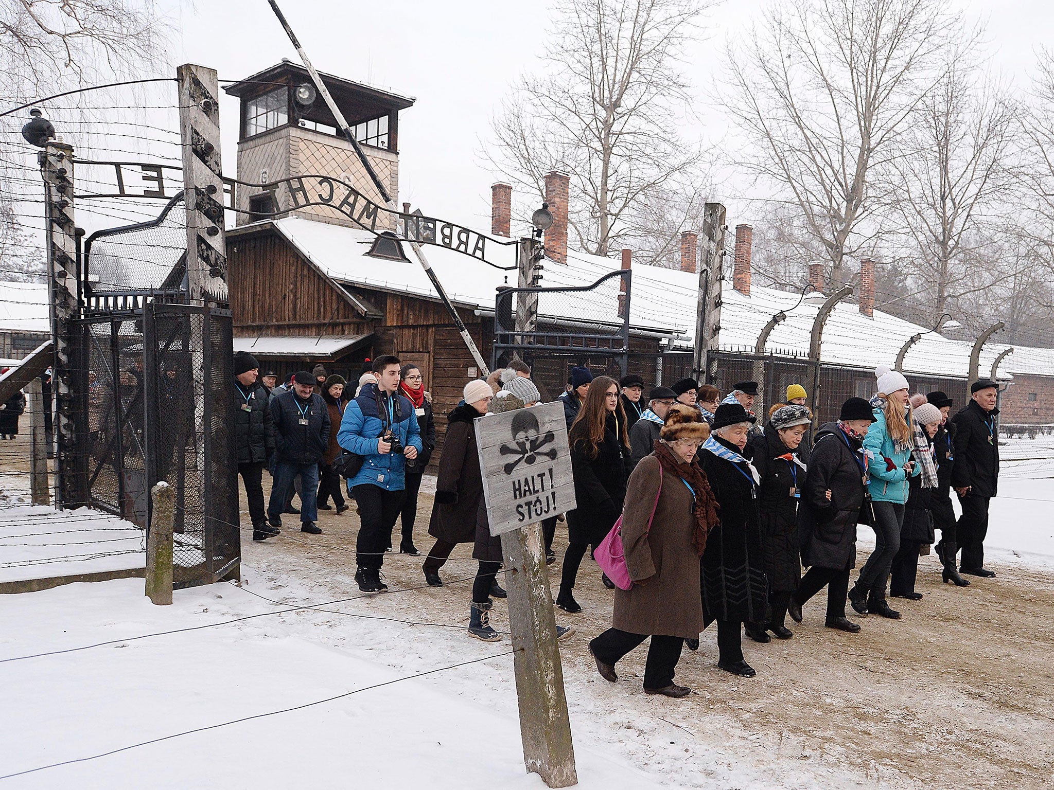 Former Auschwitz prisoners walk through the death camp's gates ahead of Holocaust Memorial Day commemorations