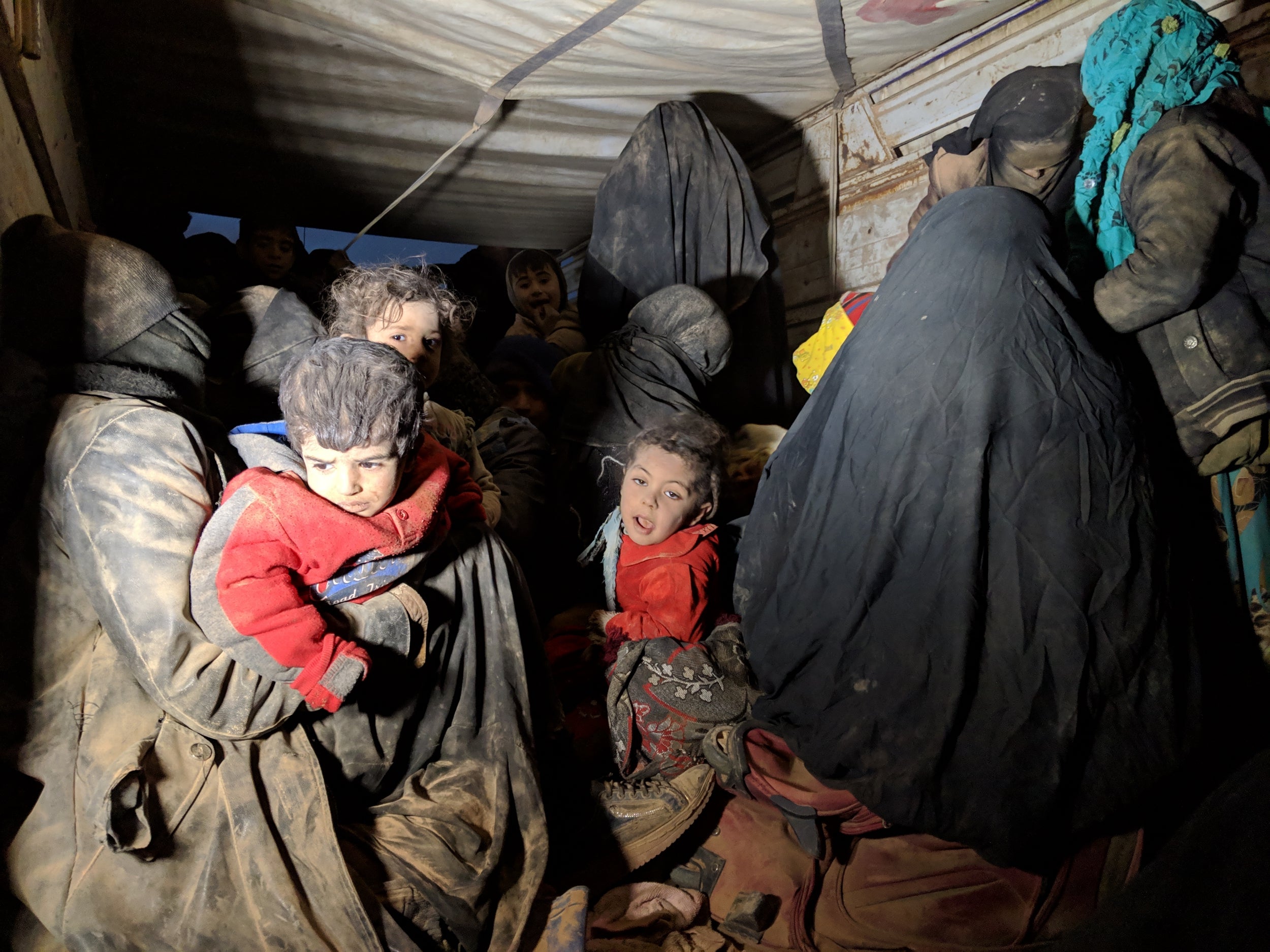 Families being transferred in a bus from Isis-held areas in Deir ez-Zor to camps further north