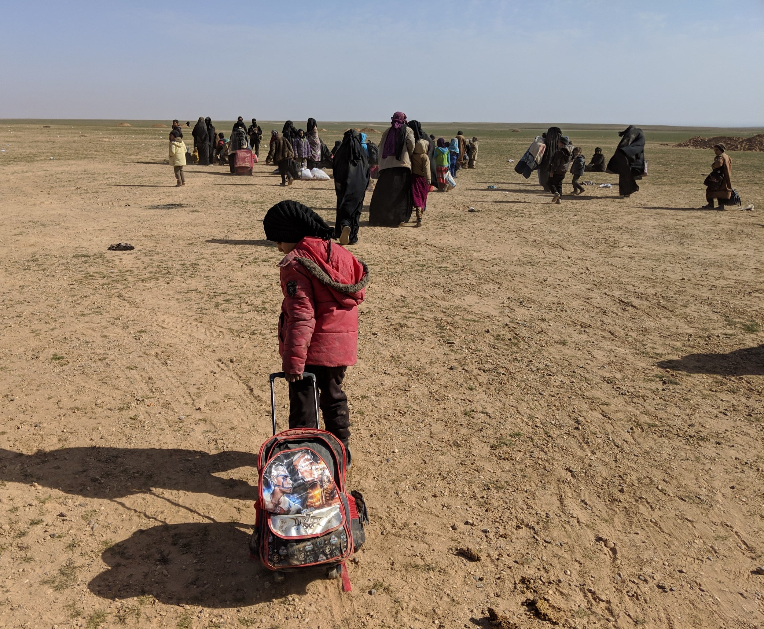 A young girl pulls her belongings after arriving from the last Isis-held areas in Deir ez-Zor, Syria, on Saturday 26 January