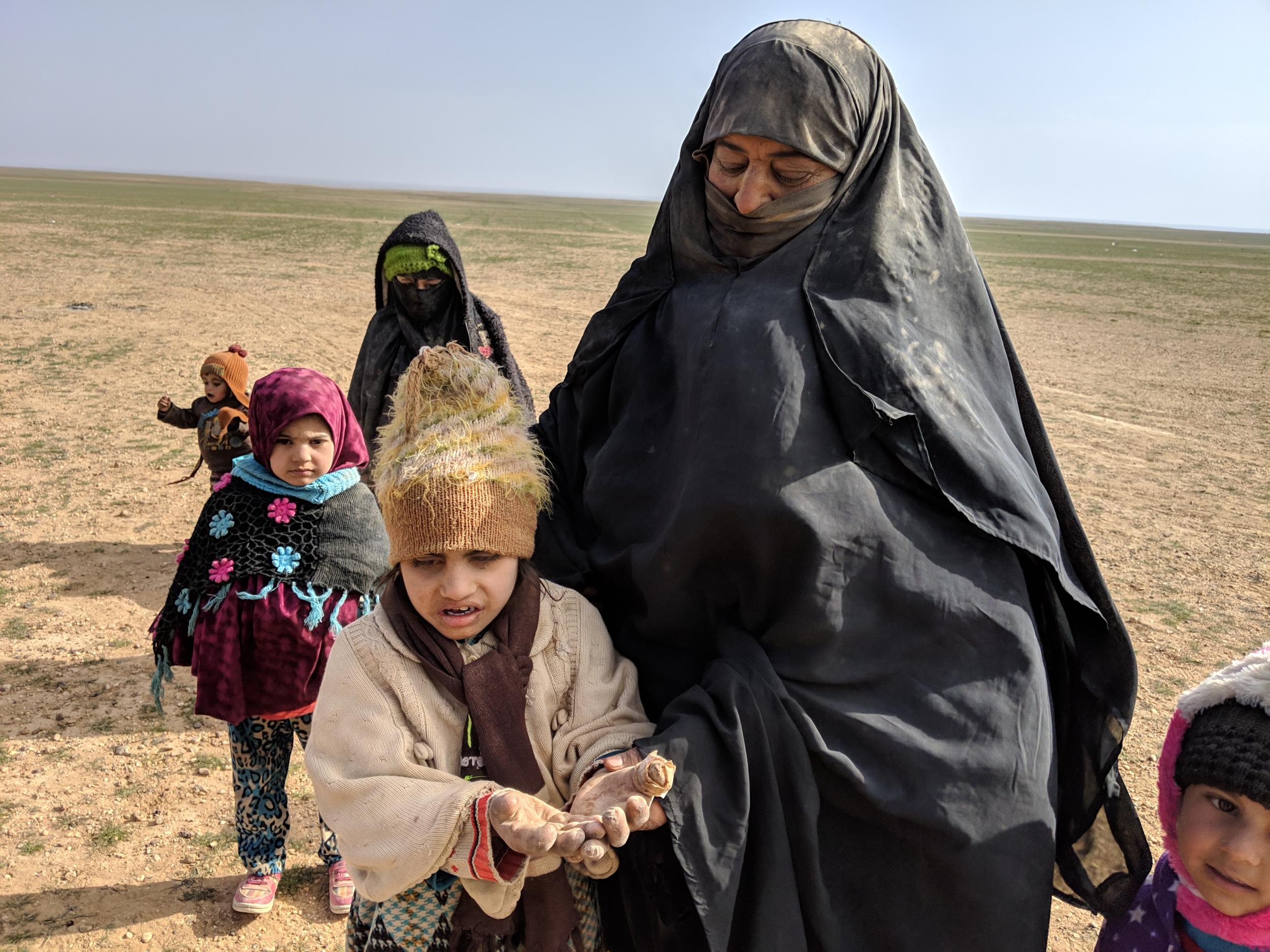 Nidal Hamad, from the town of al-Qaim, in Iraq, with her granddaughter, who was injured when fighting forced them to flee to Syria