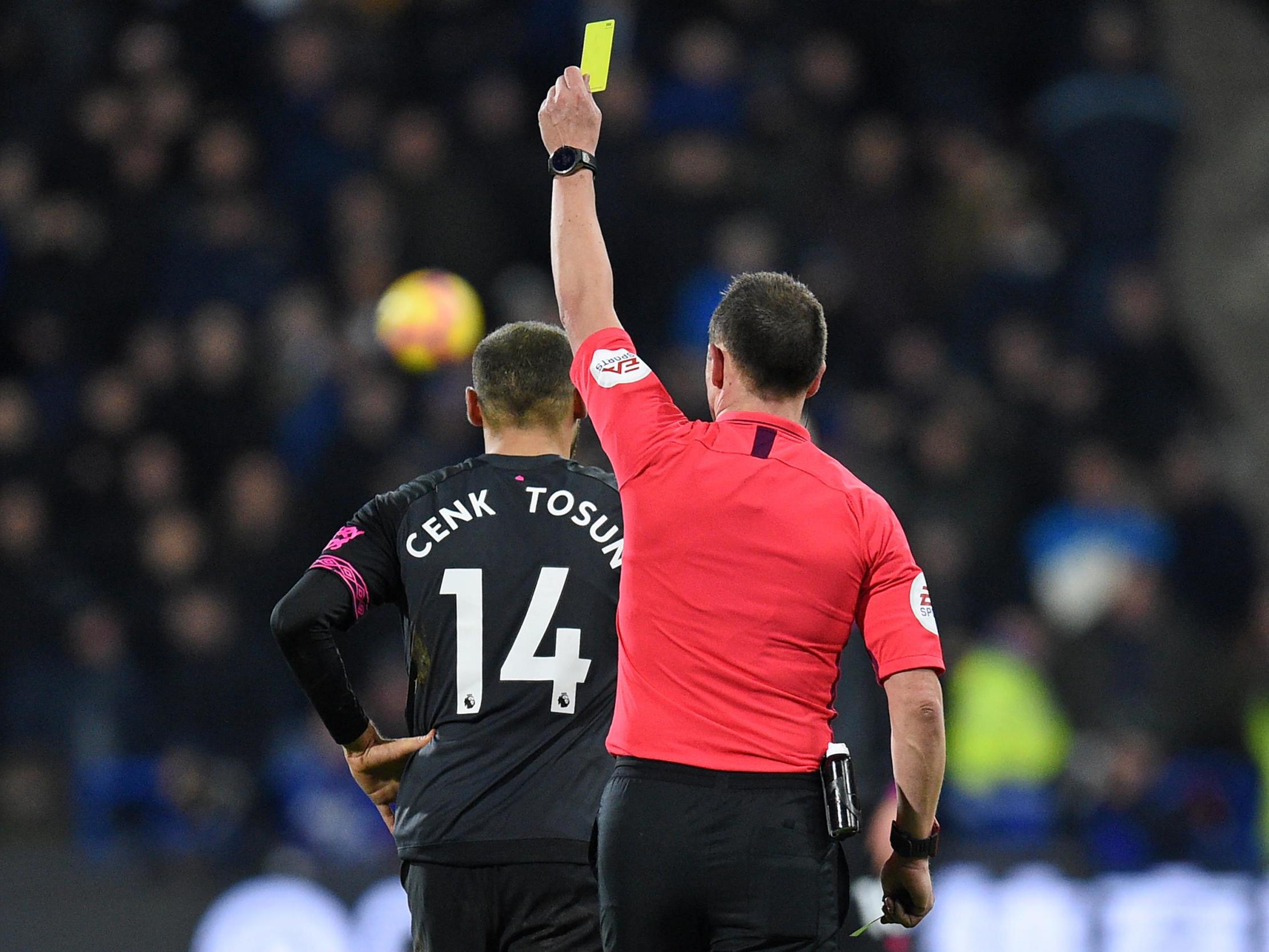 Cenk Tosun receives a yellow card from referee Stuart Attwell