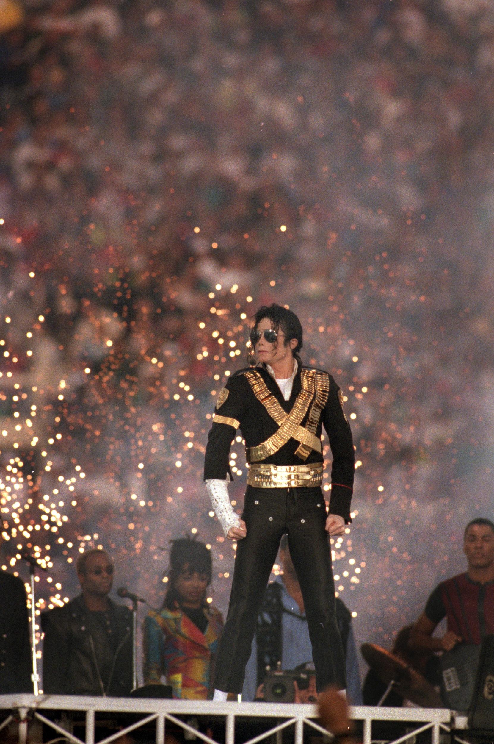 1993 - Michael Jackson
<br><br>
For what is arguably the most memorable halftime performance to date, Michael Jackson wore a gilded military-inspired jacket over a white button-down shirt, black trousers and a pair of aviator sunglasses. He also sported his iconic white socks and black loafers