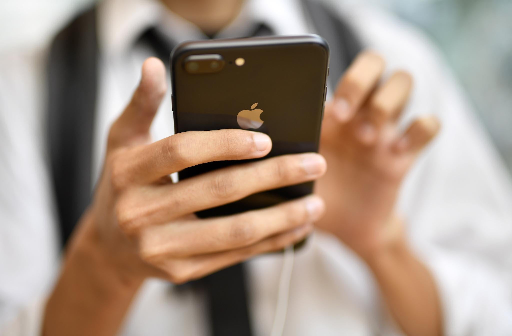 A young man looks at Apple's iPhone 8 Plus at the Apple Store of Omotesando shopping district in Tokyo, Japan