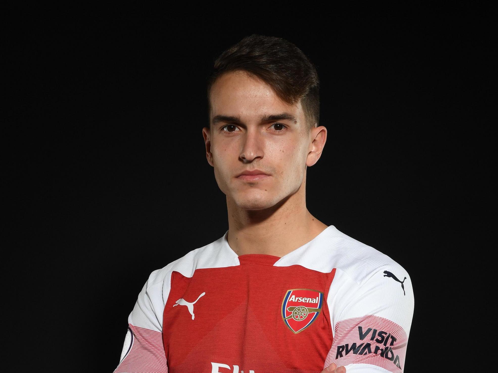 Denis Suarez poses with the Arsenal shirt