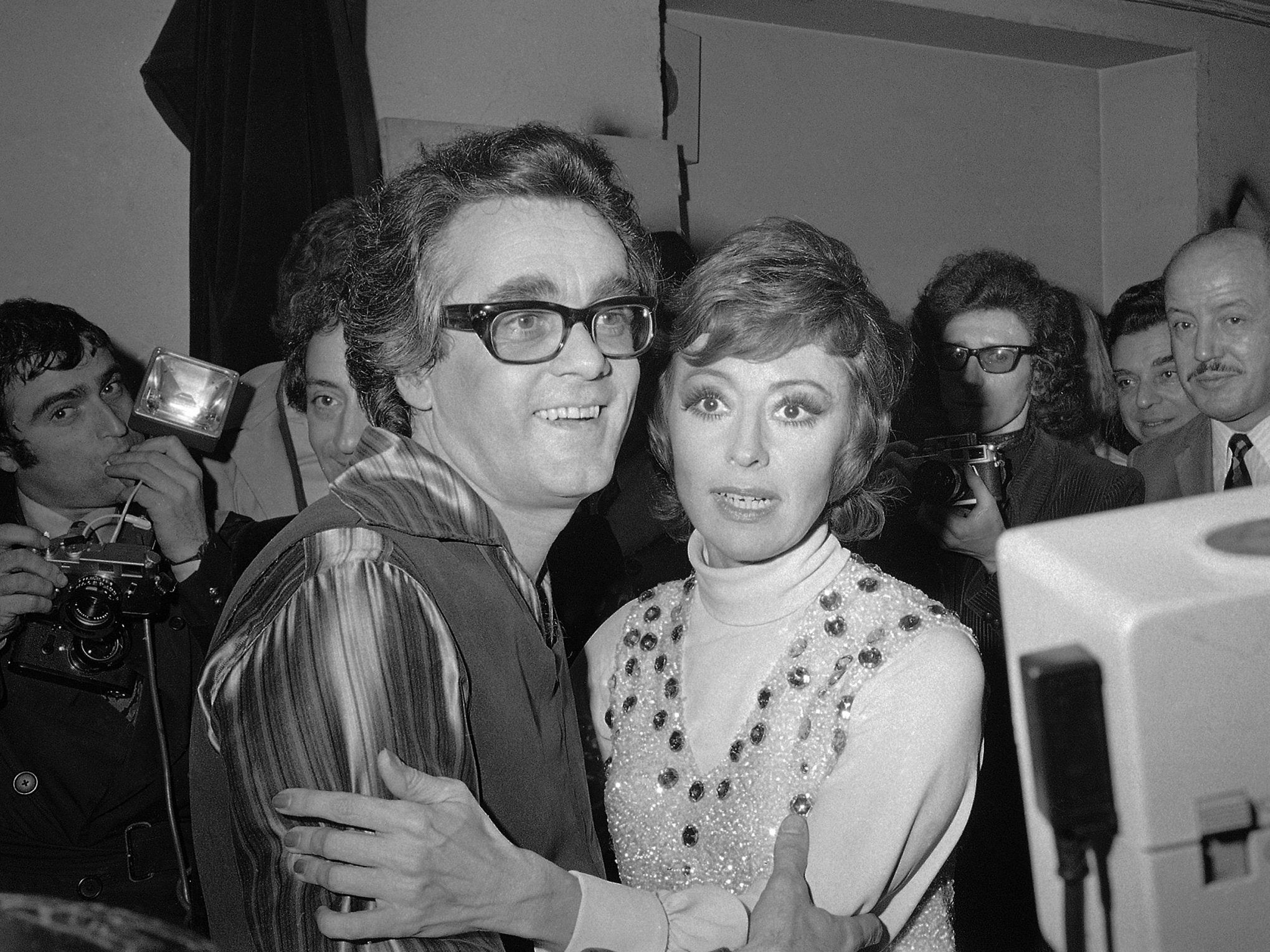 Michel Legrand and Italian singer Caterina Valente embrace after their show a the Olympia concert hall, Paris, in 1972