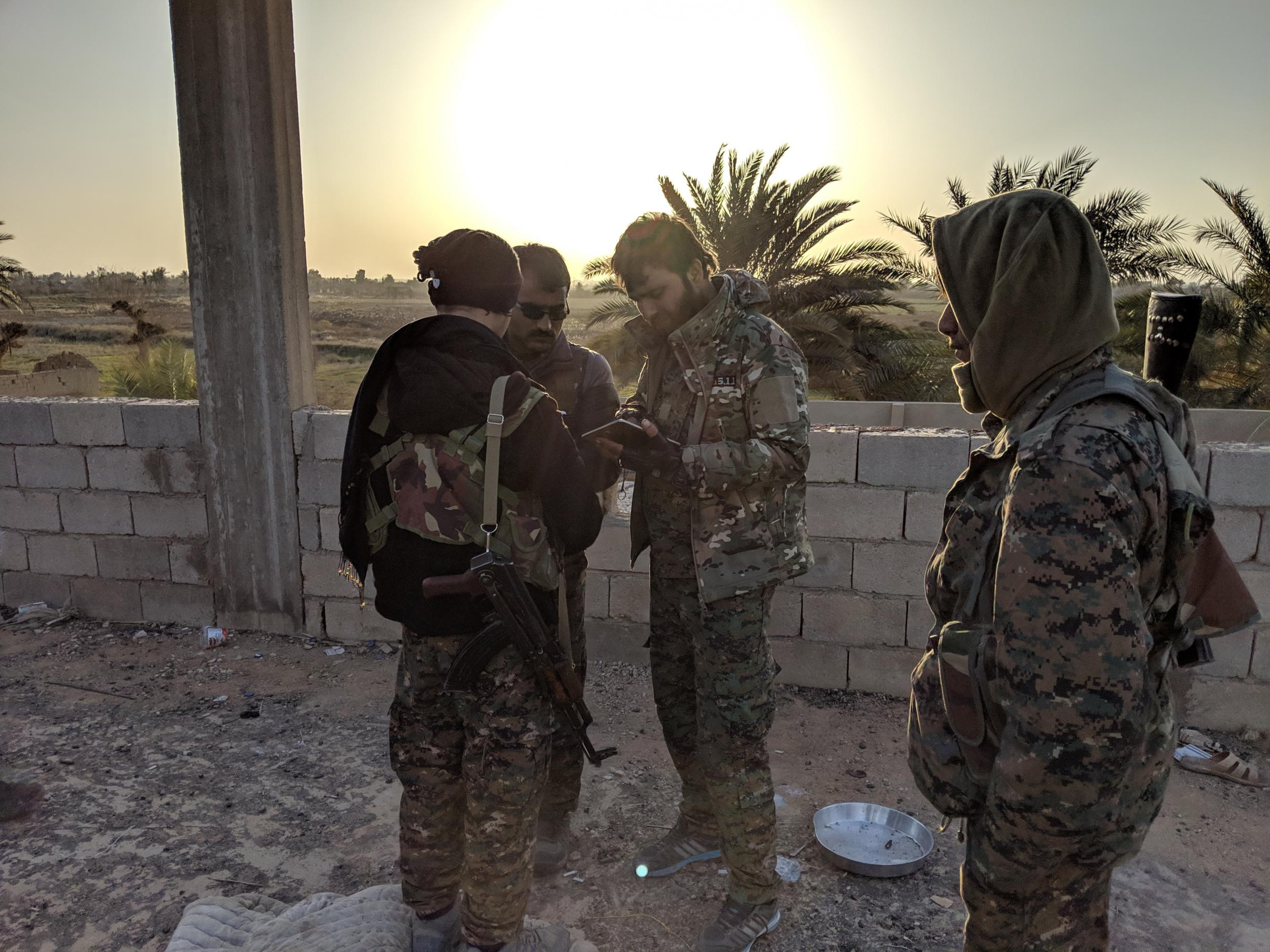 SDF fighters gather near the front line against Isis in the village of Baghouz Tahtani, eastern Syria