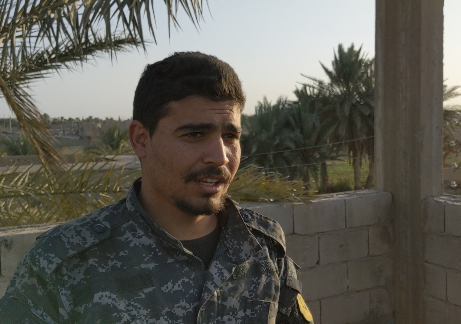 Masloon Derbasiyeh, a 23-year-old fighter with the Syrian Democratic Forces, near the front line with Isis, in the last days of the caliphate (Richard Hall/The Independent)