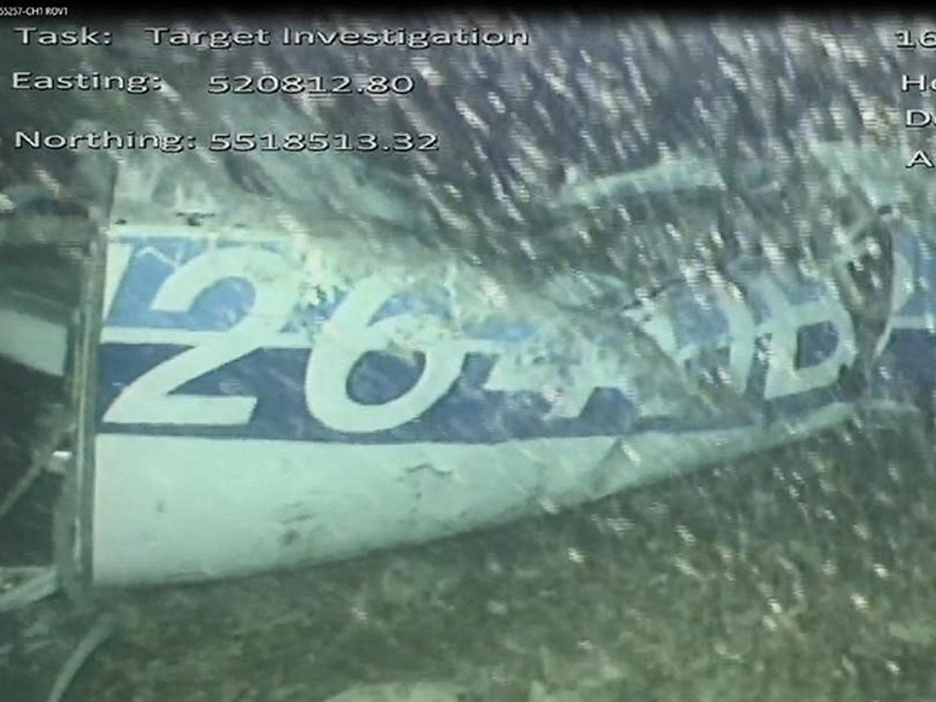 An underwater image shows one side of the wreckage