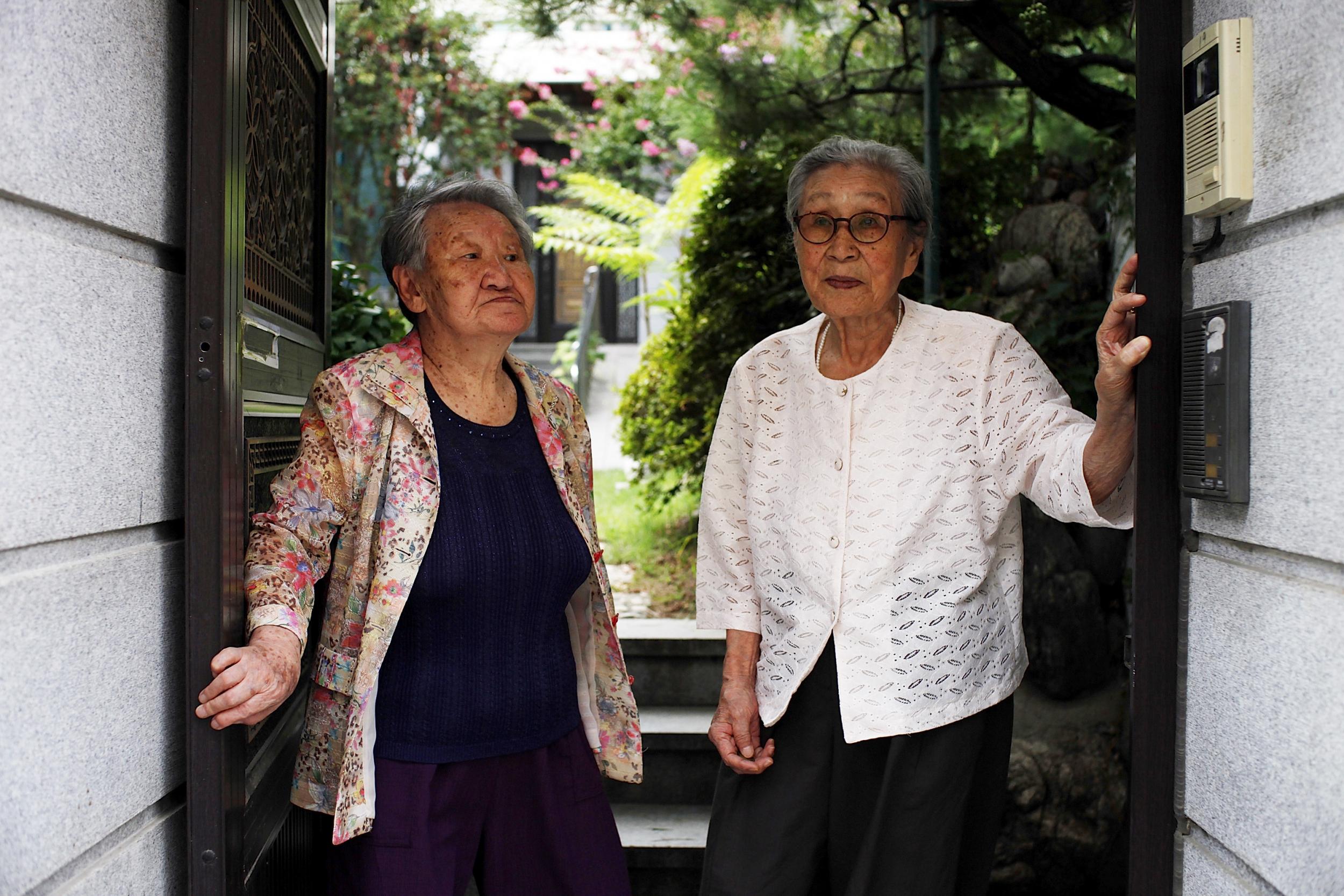 Kim (right) and Gil Won-ok wait to leave the survivors’ shelter in 2016