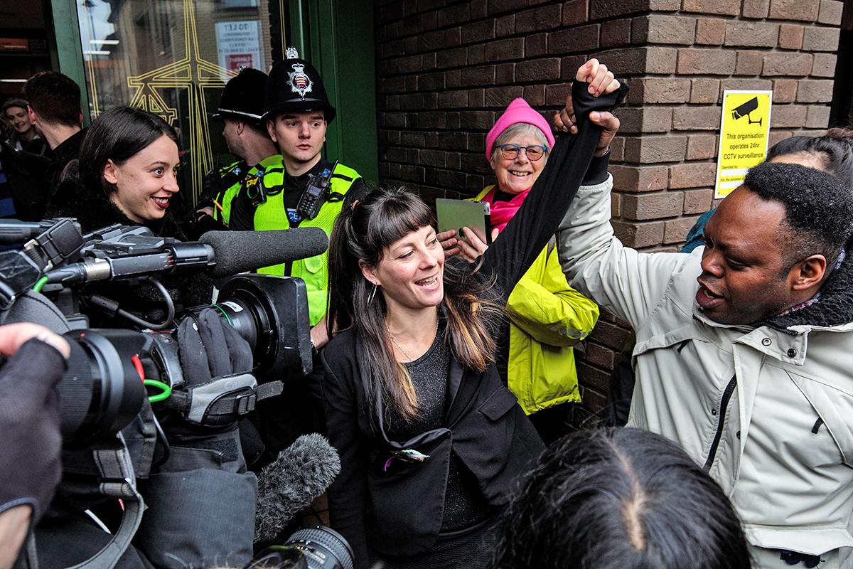 May McKeith, a member of the 15, raises a fist as she leaves Chelmsford Crown Court